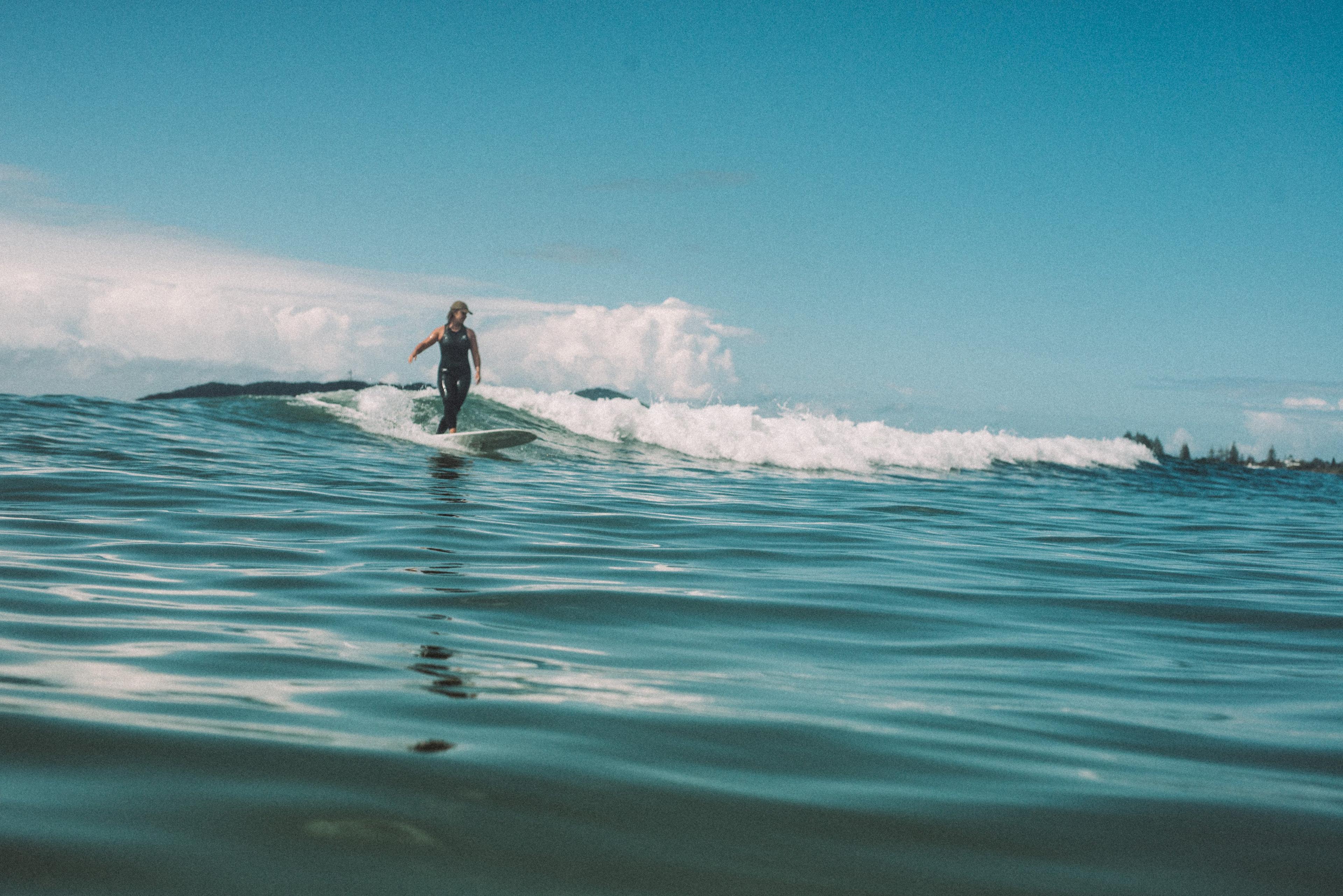 Atmosea Dad Cap - Vintage Khaki on surfer catching a wave