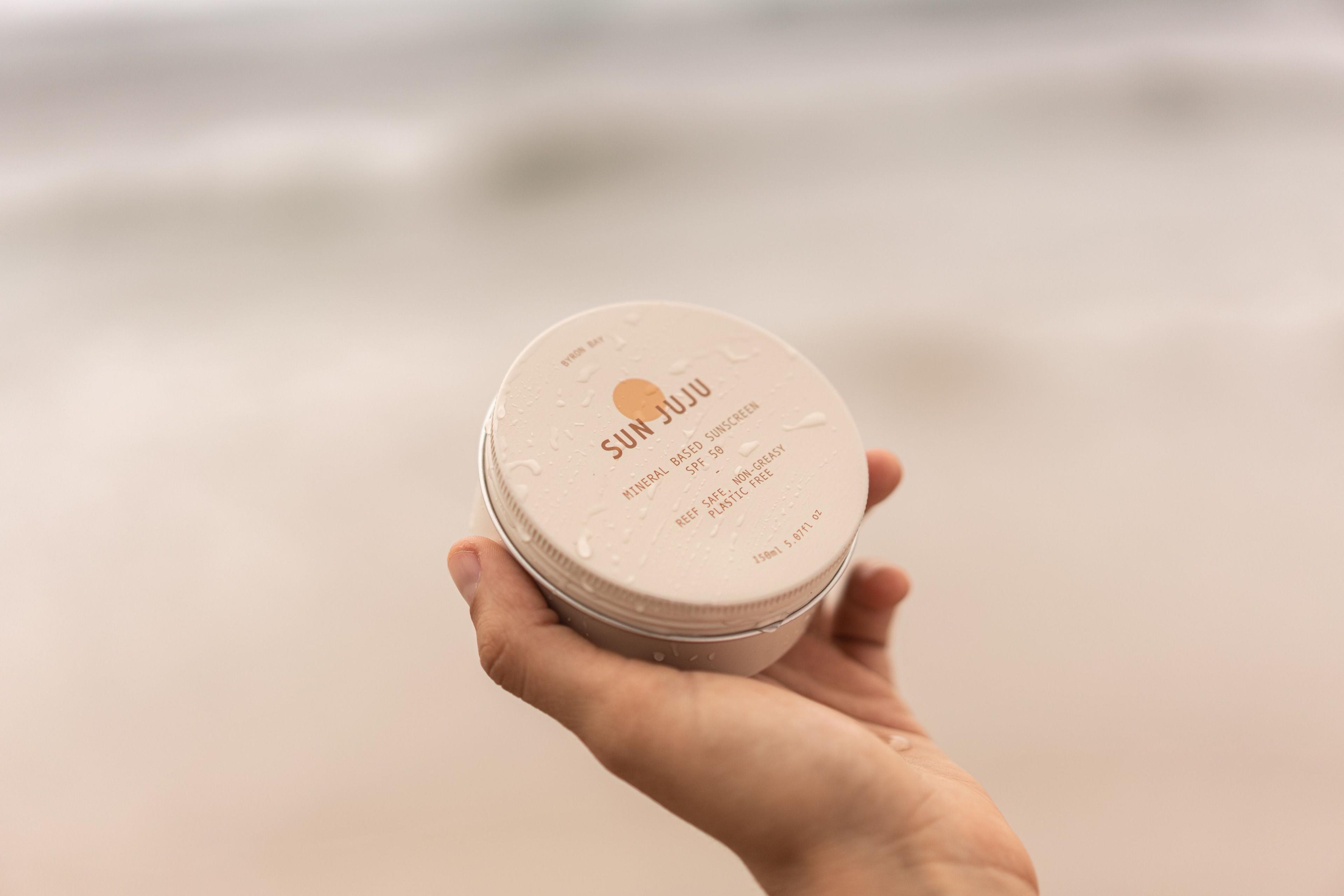 Sun Juju Reef Safe Mineral Based SPF50 Sunscreen tin in hand