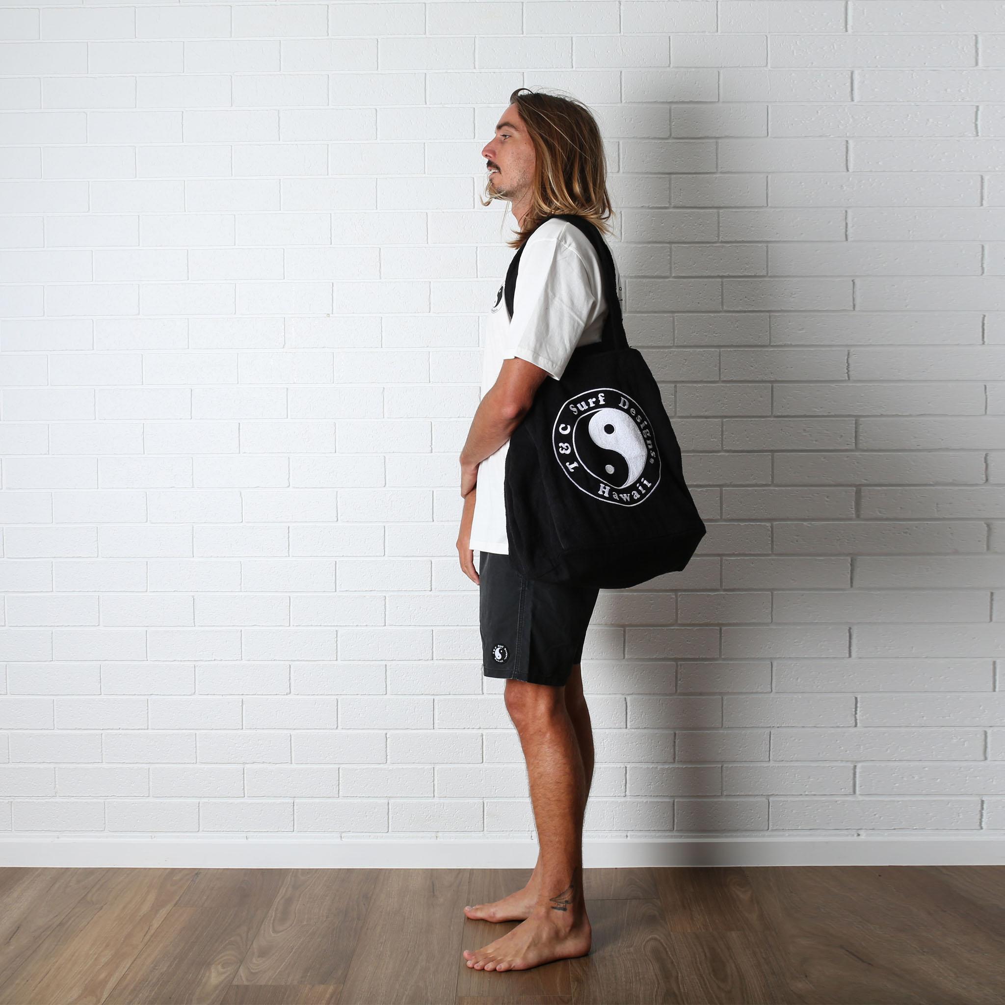 T&C All Day Beach Bag - Black on man's shoulder