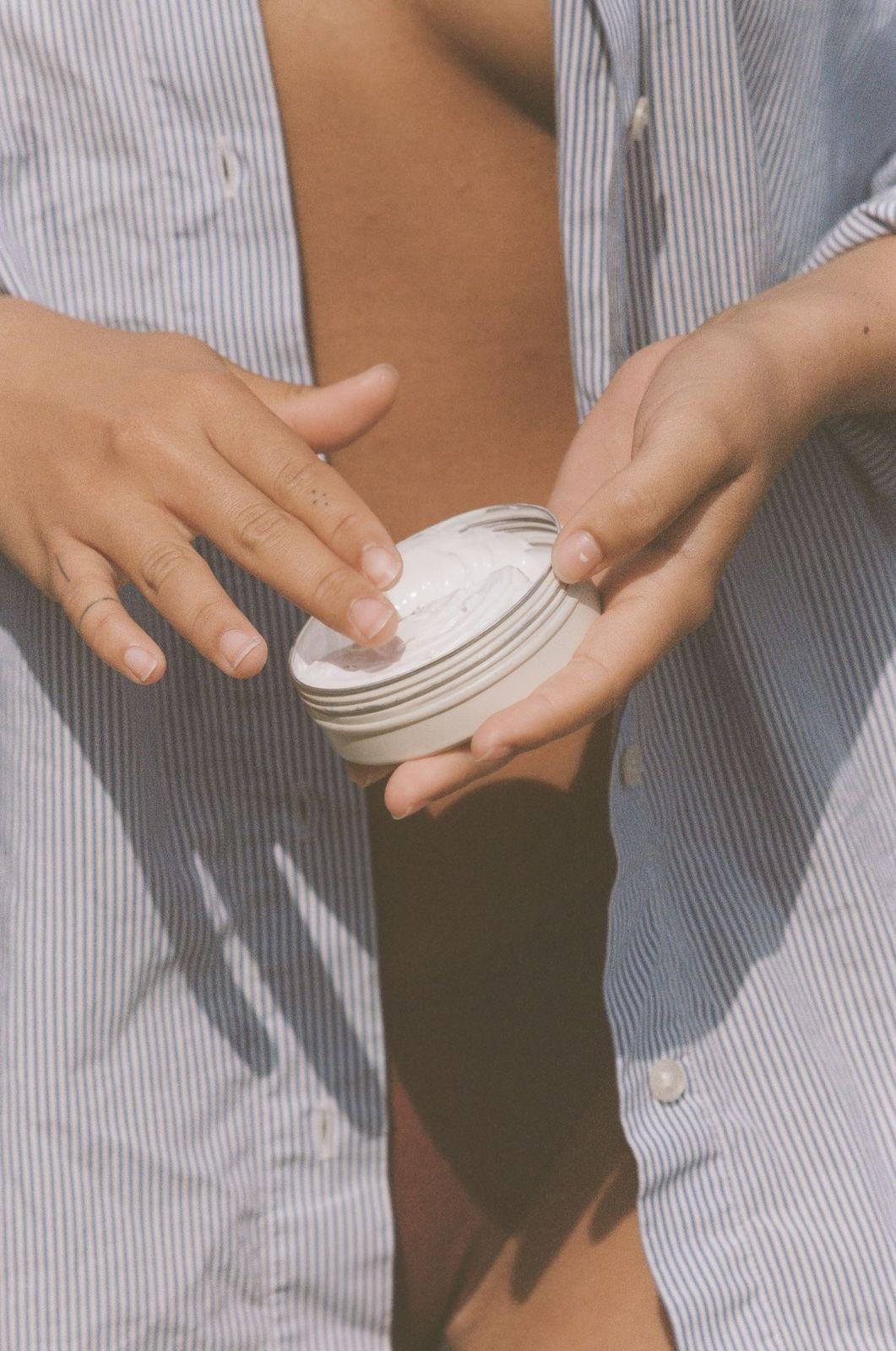 Sun Juju Mineral Based SPF50 Sunscreen Cream on fingers