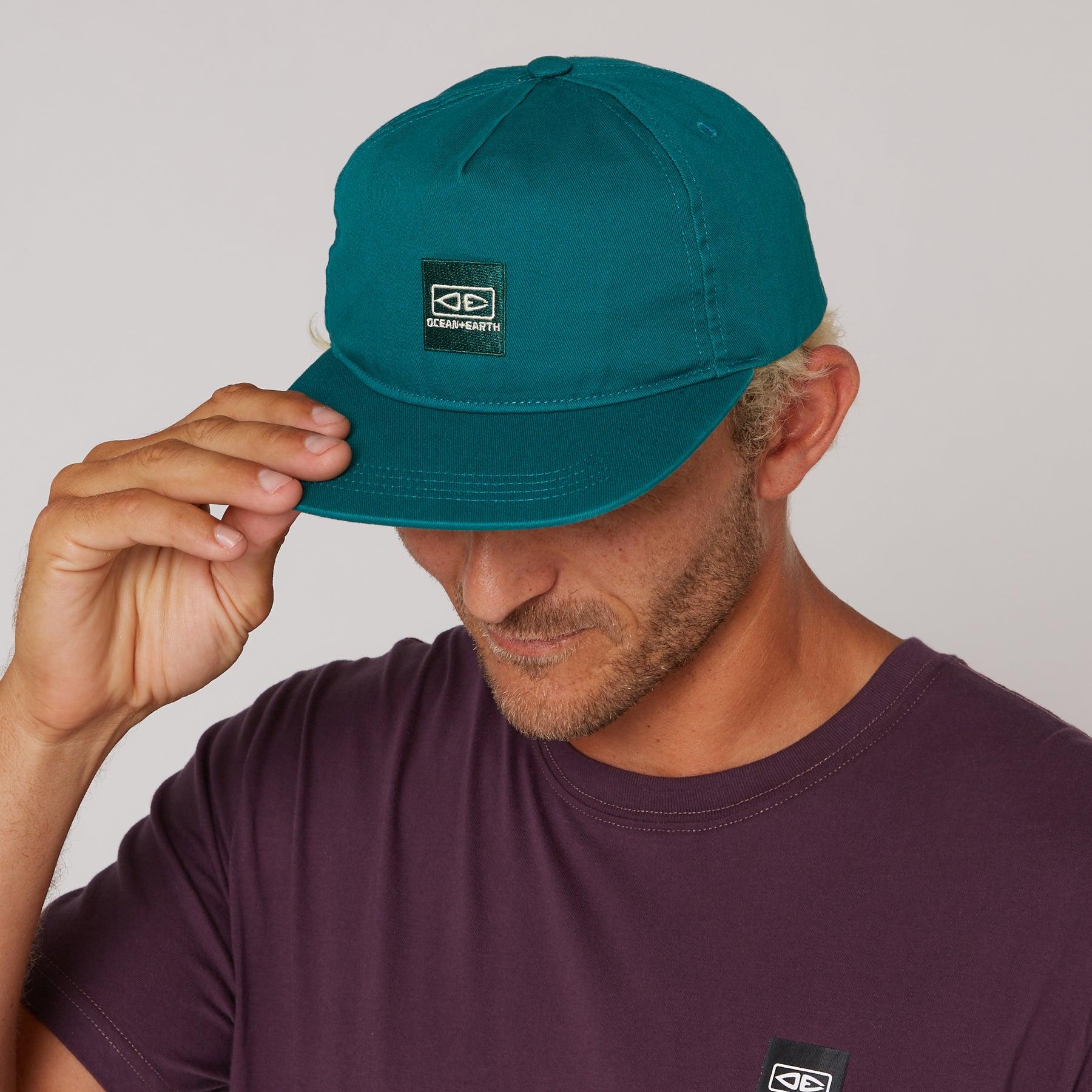 Close-up of teal Corp Cap