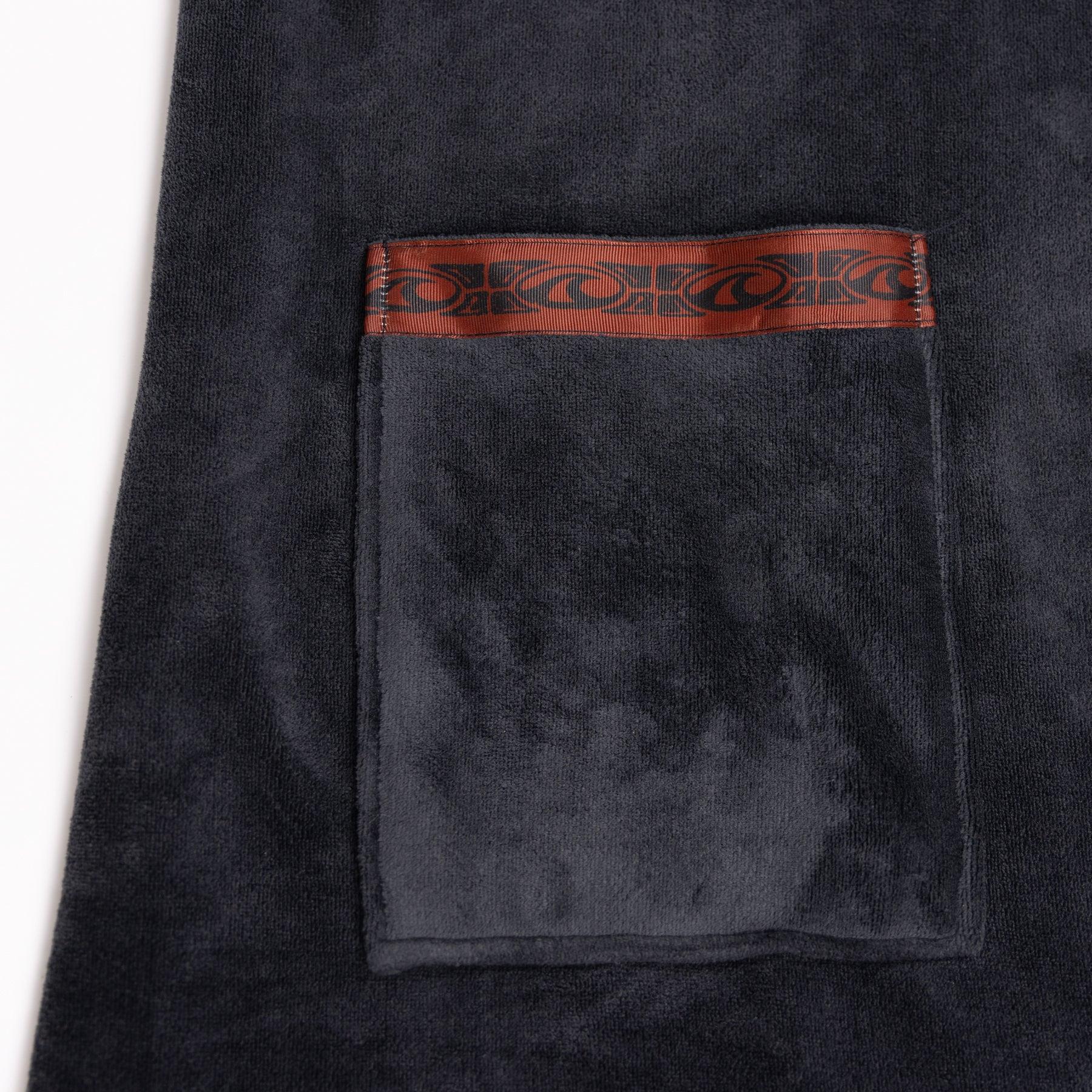 Back view of dull black poncho