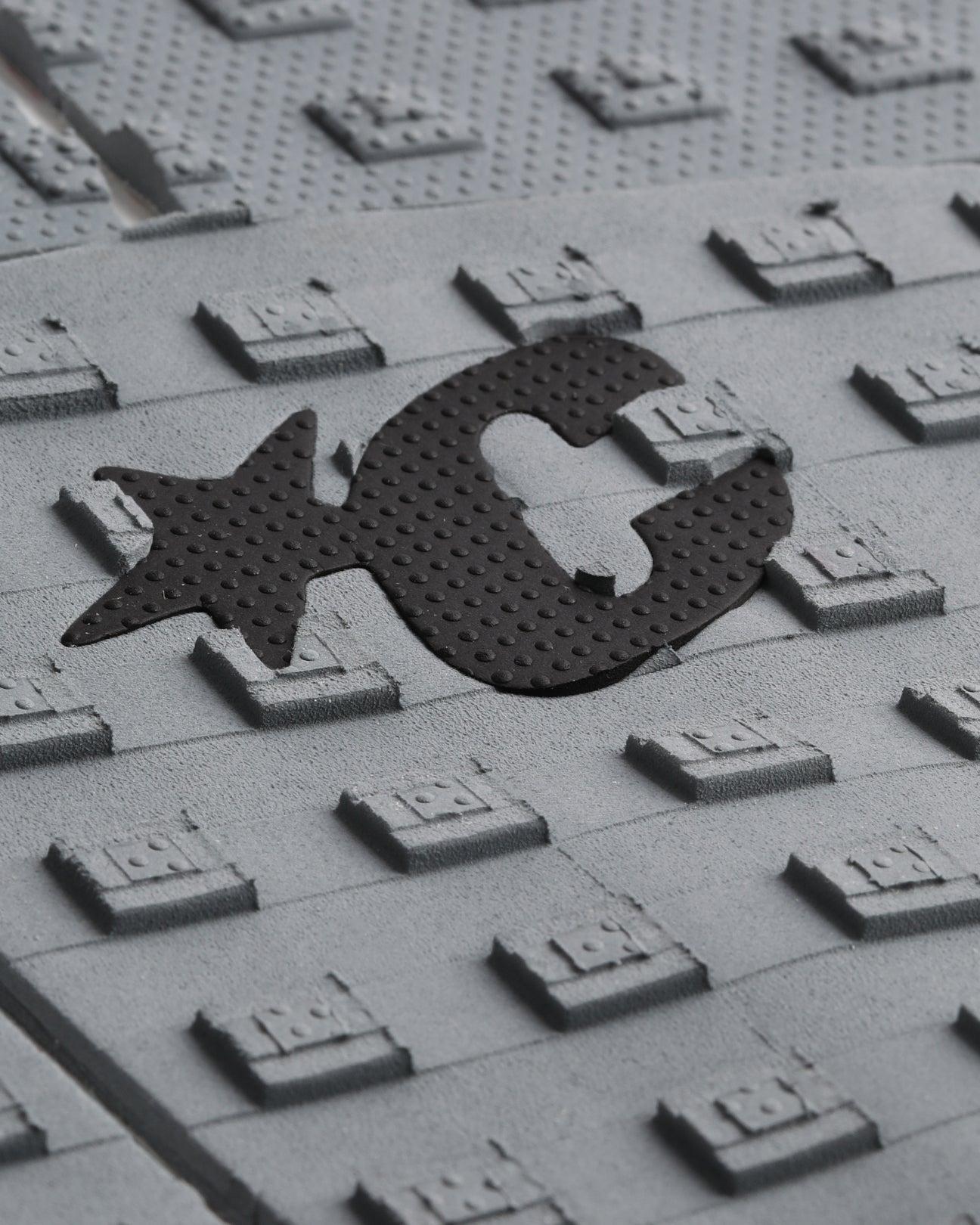 Close-up of logo on grey traction pad