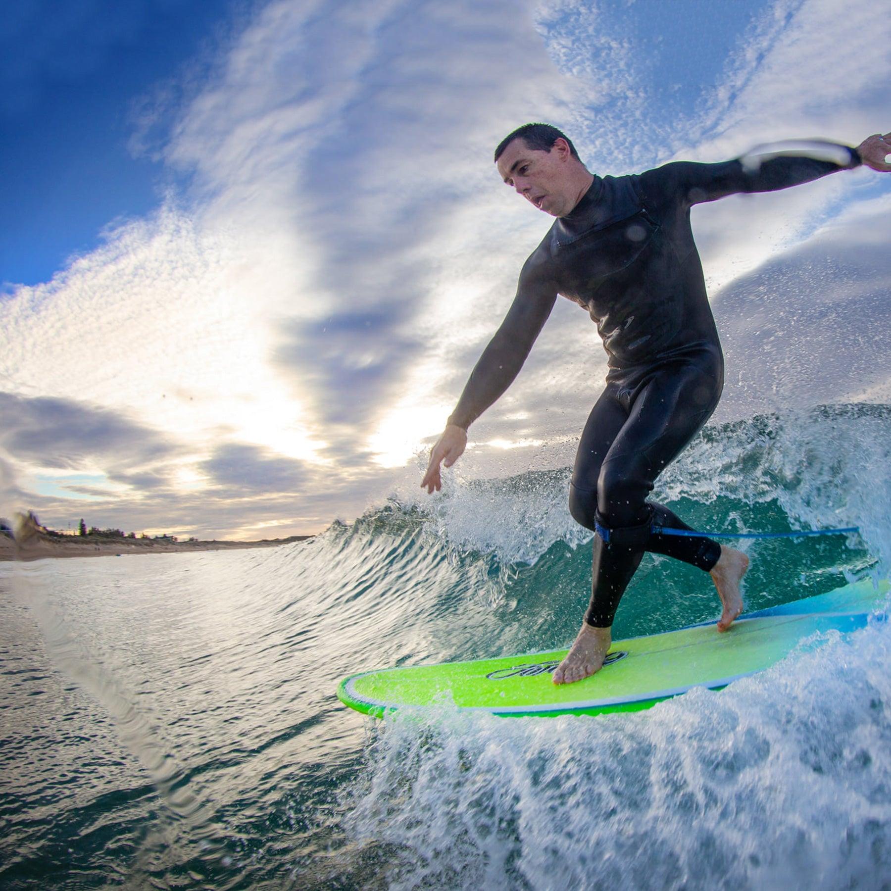 Surfer Riding Wave with Leash