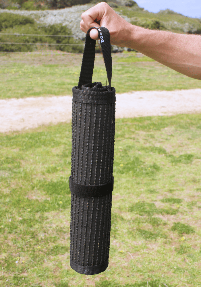 Close-up of feet on sand mat