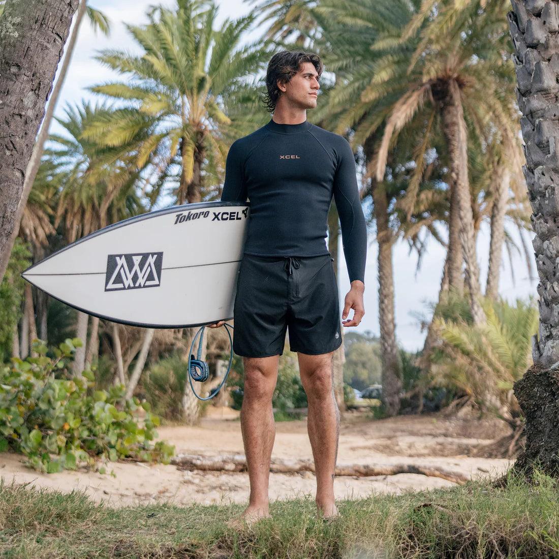 Man with surfboard on beach