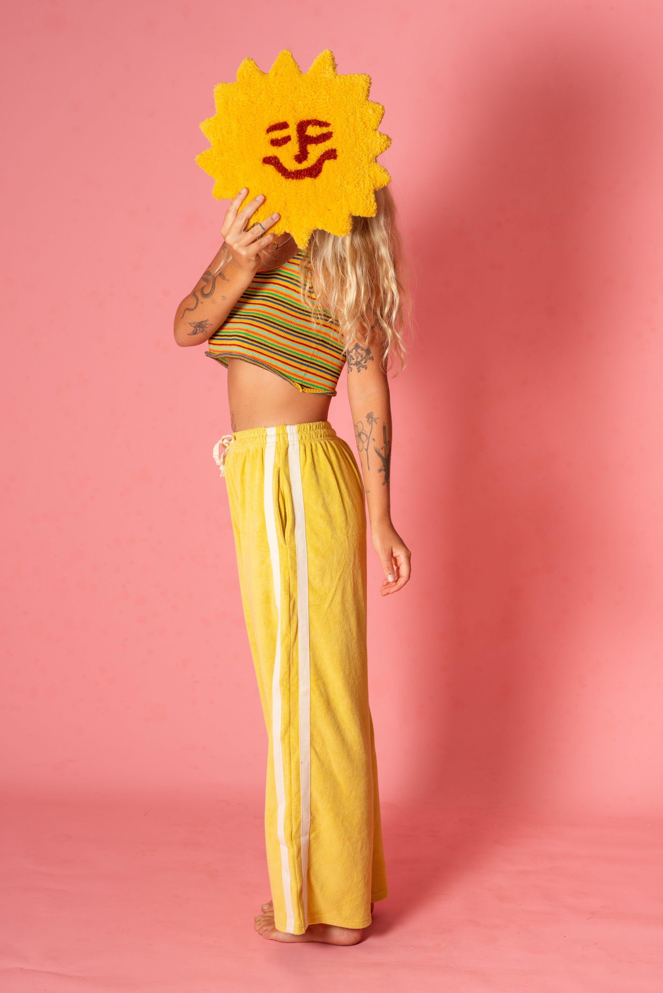 Model with sun rug and yellow pants