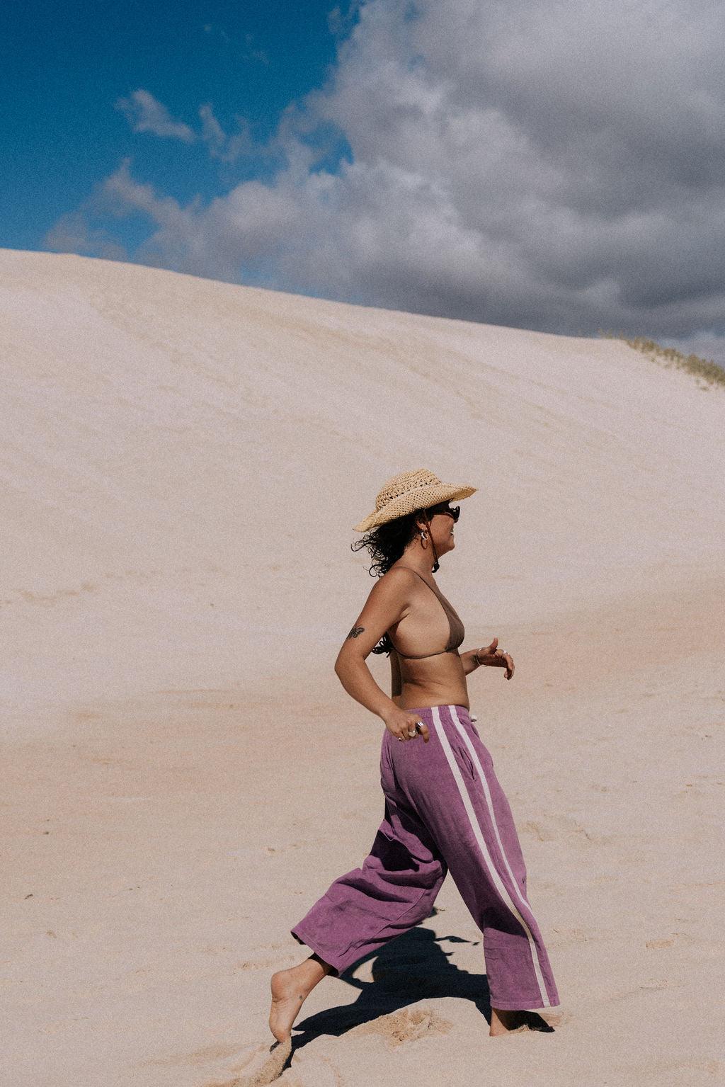 Purple pants on sand