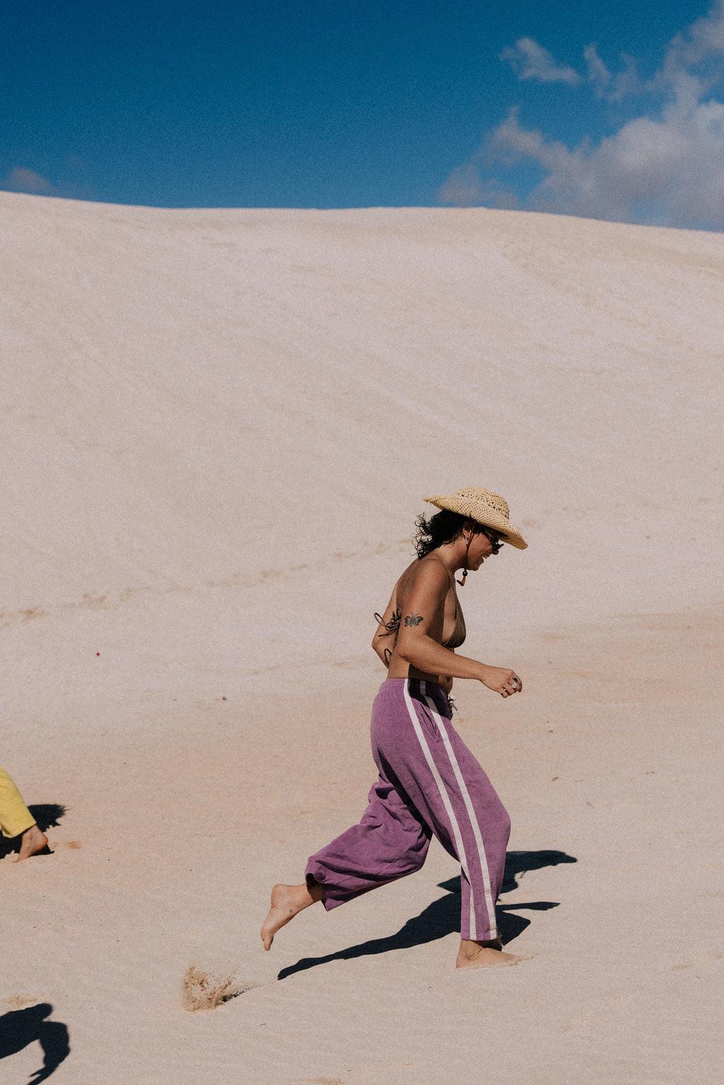 Model in purple pants on beach