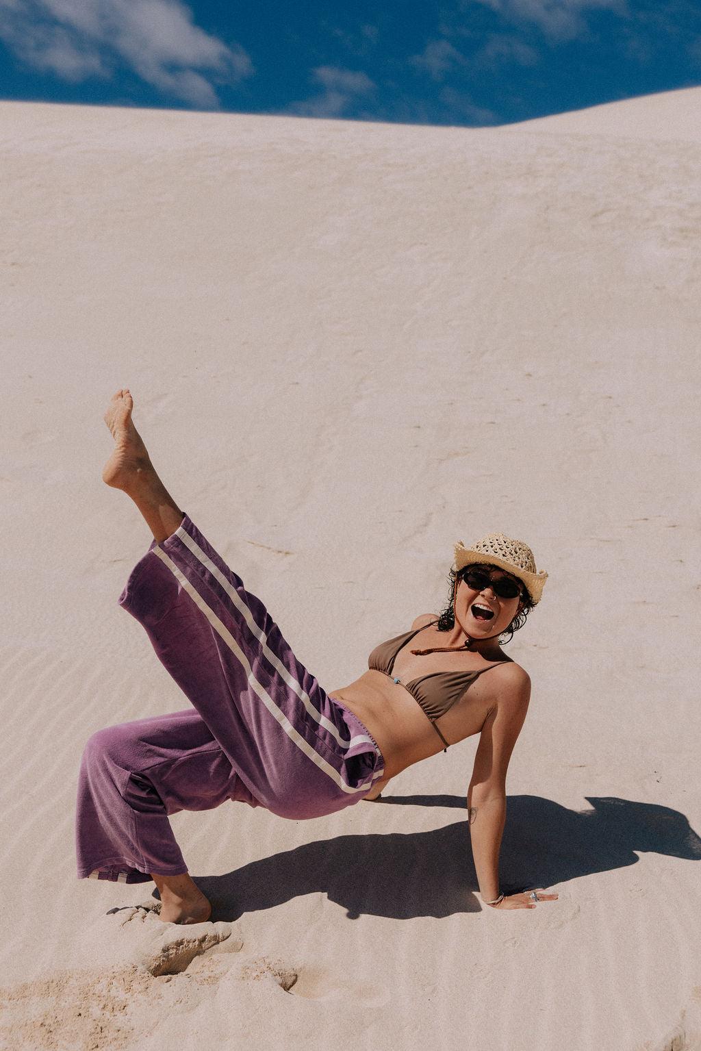 Model posing in purple pants