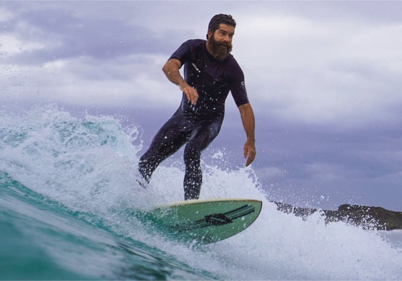 Attica Omega 3/2 Chest Zip S/S Steamer - Black/White on model in action