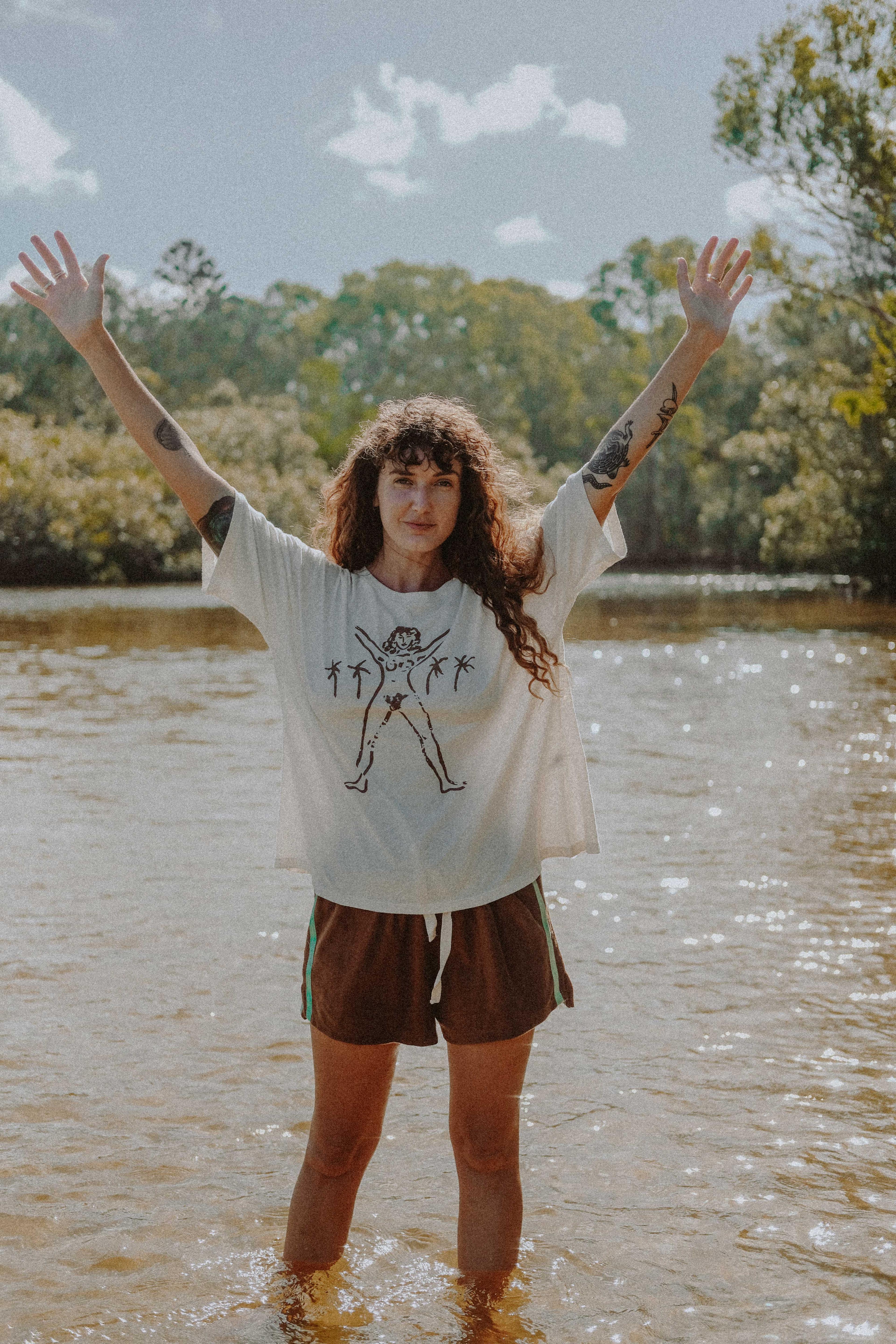 Model in Bush Woman Tee by water