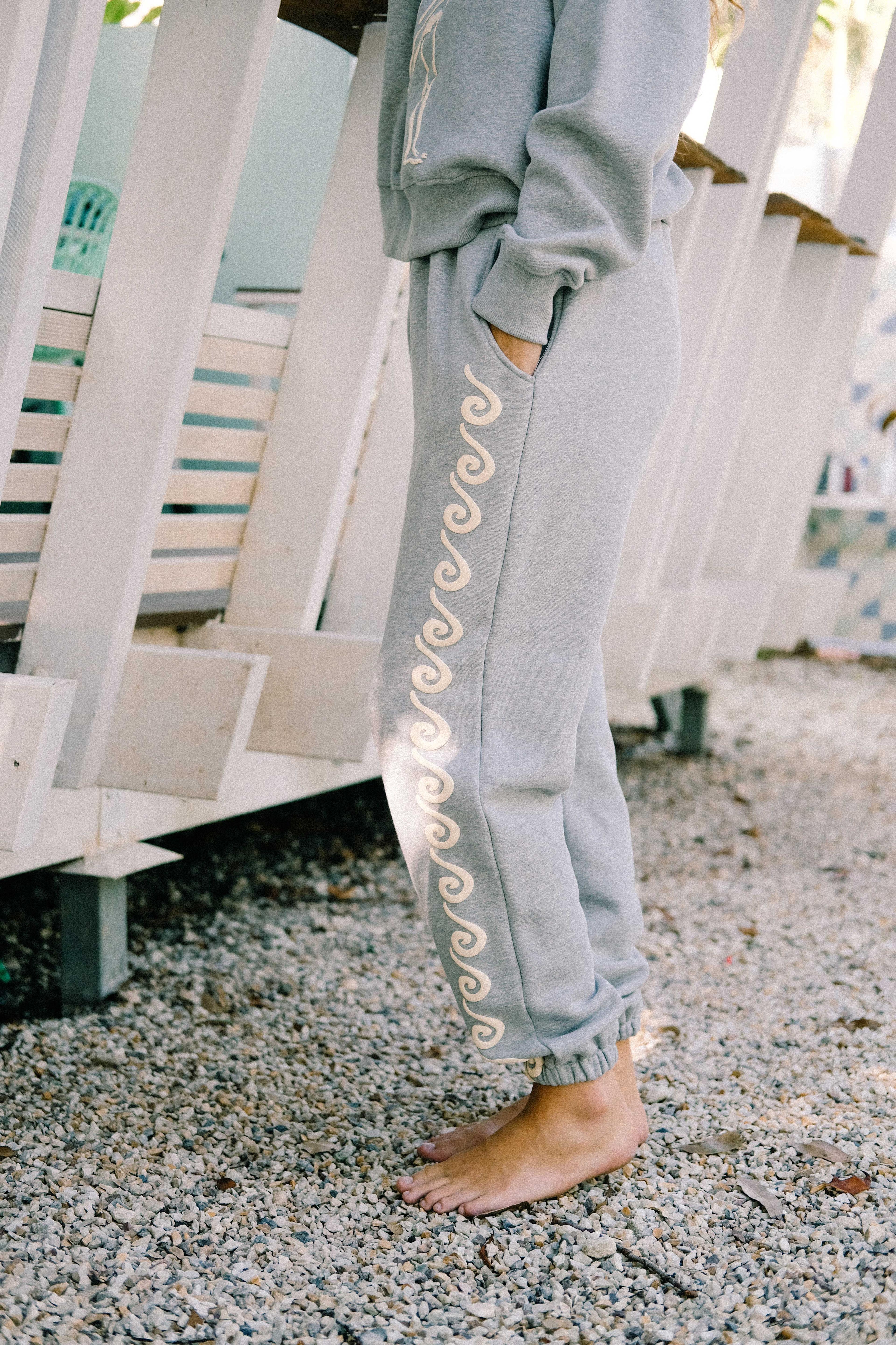 Model sitting in Bush Woman Track Pant