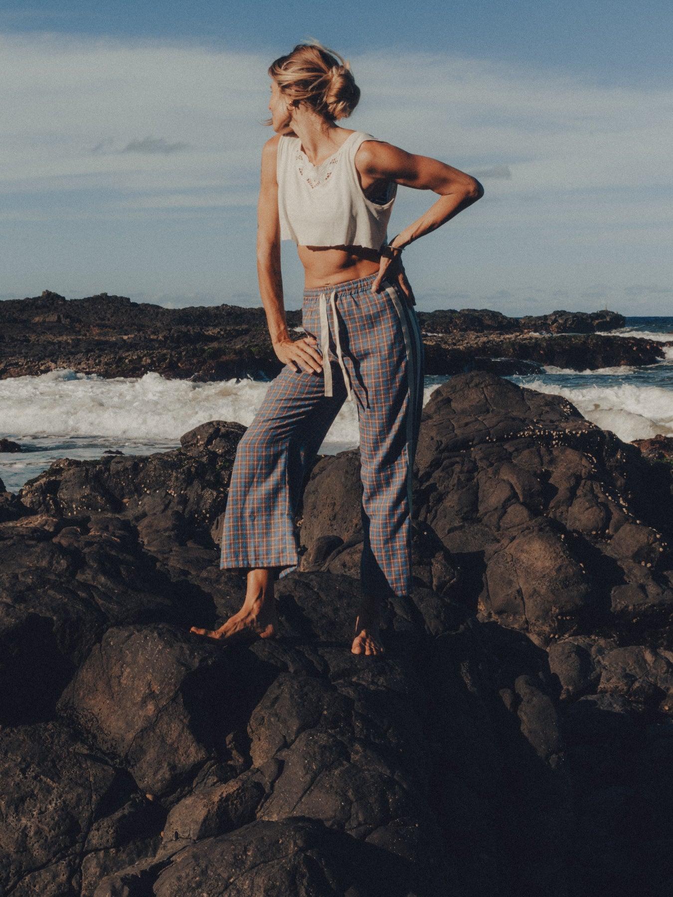 Flannel pants on rocks by sea