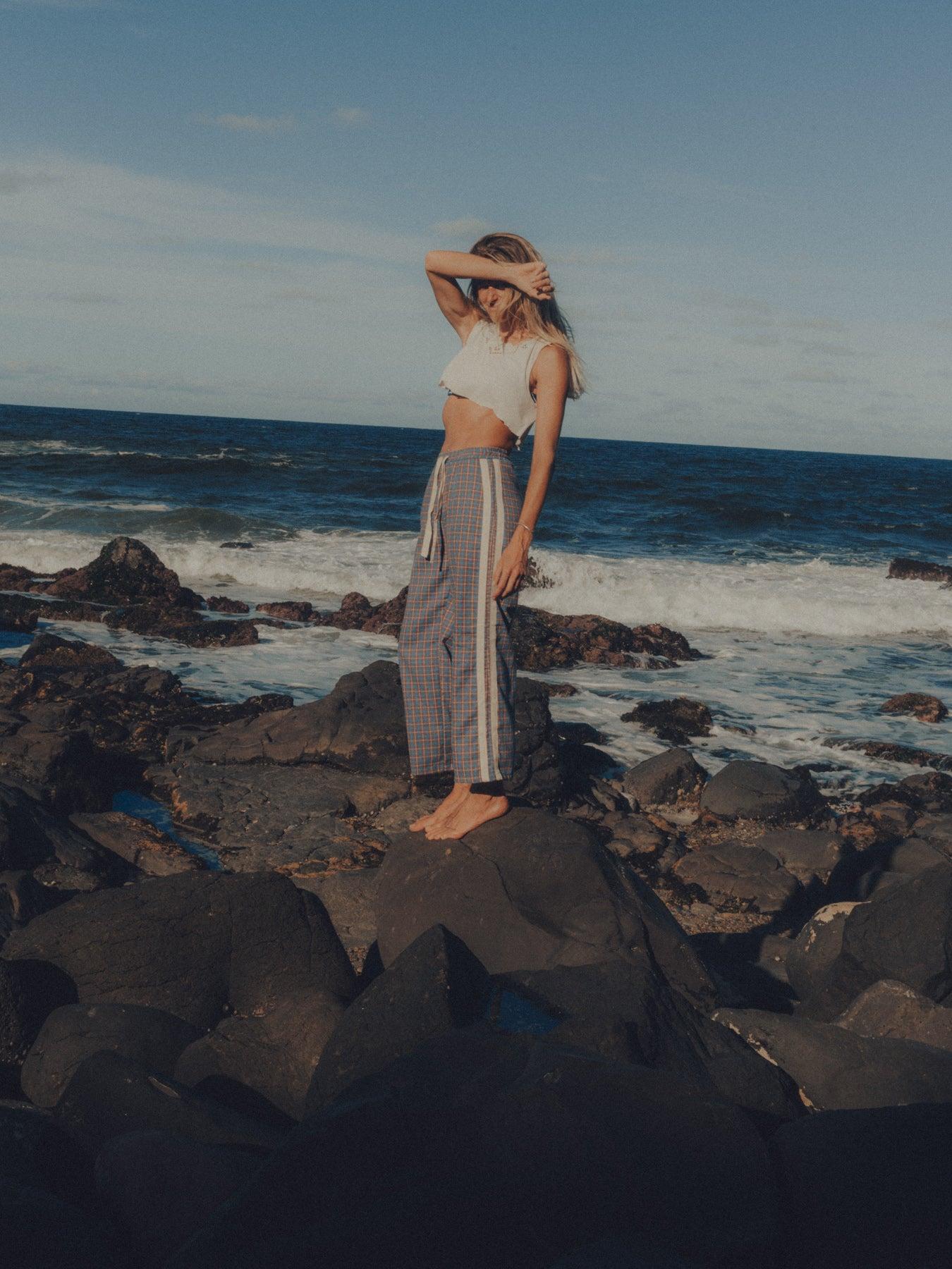 Flannel pants on rocks standing