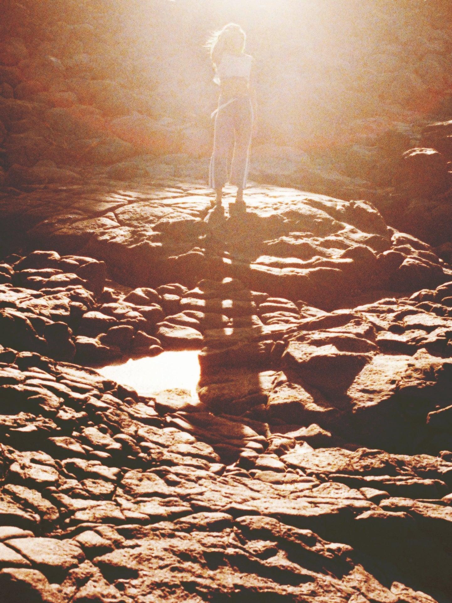 Flannel pants on rocks with ocean