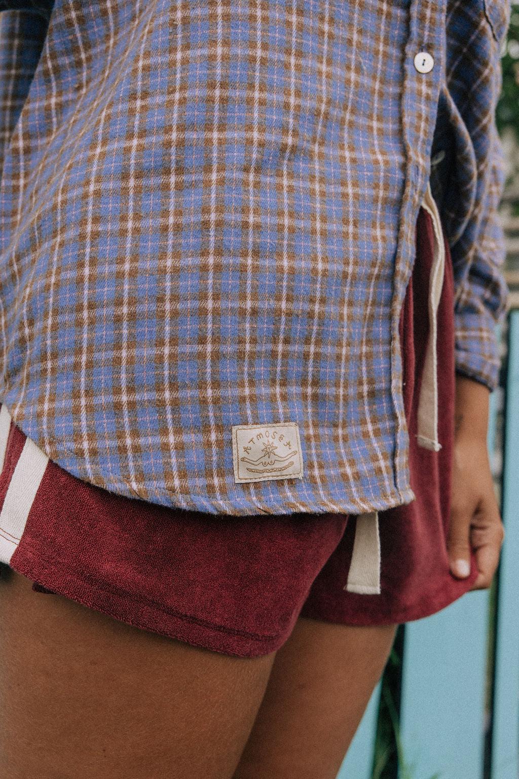 Model in flannel shirt by station
