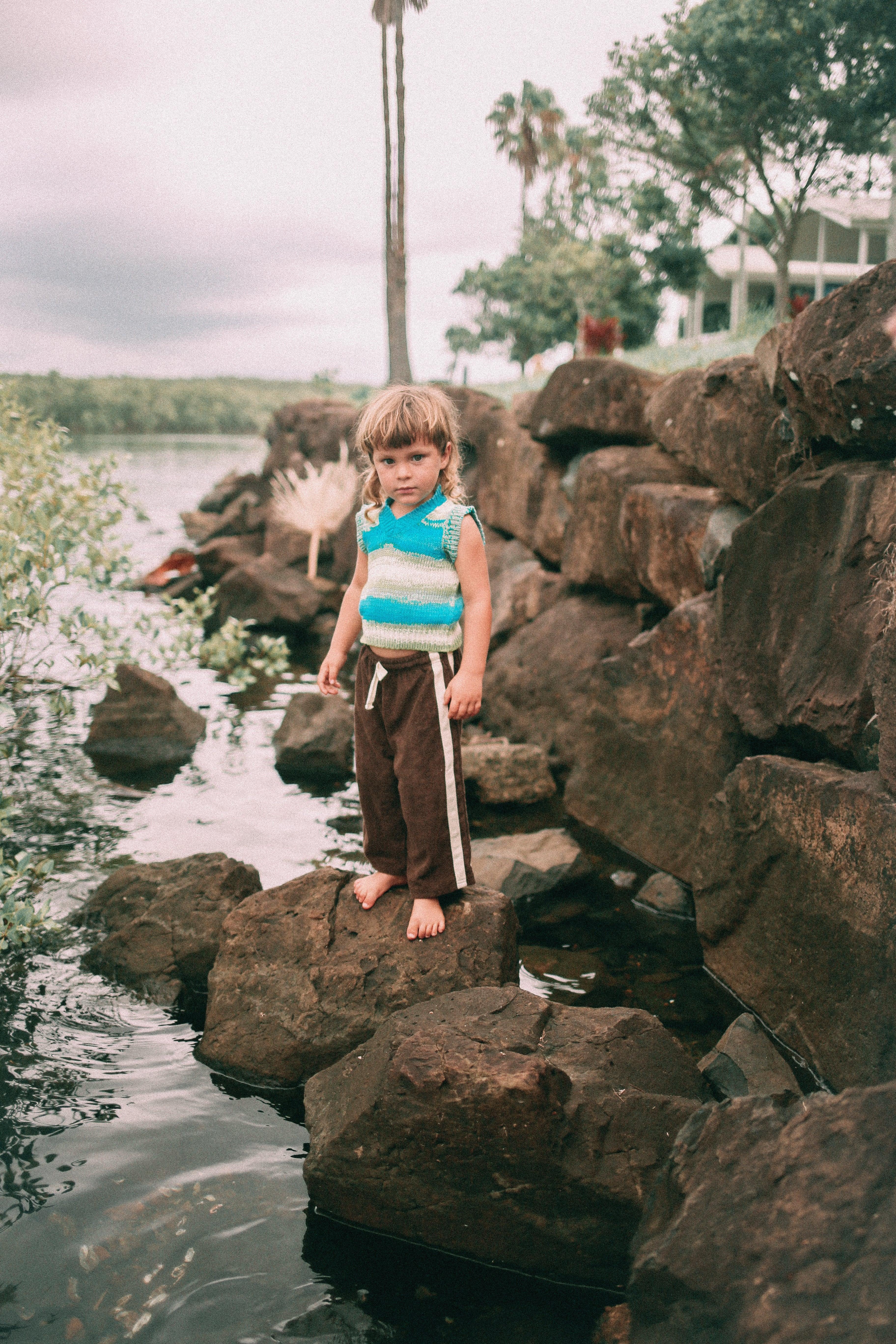 Child and adult on rocks