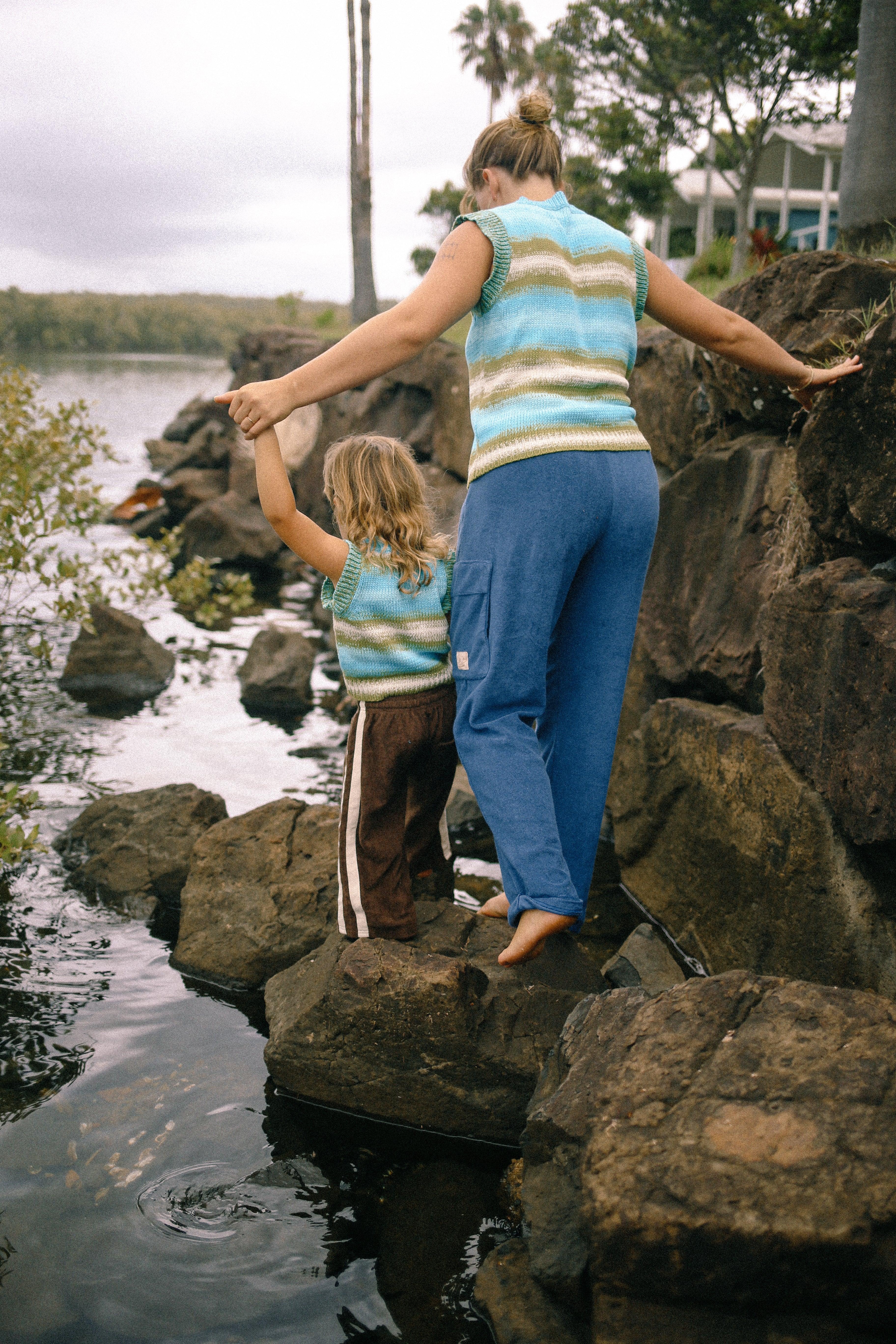 Child in vest by water