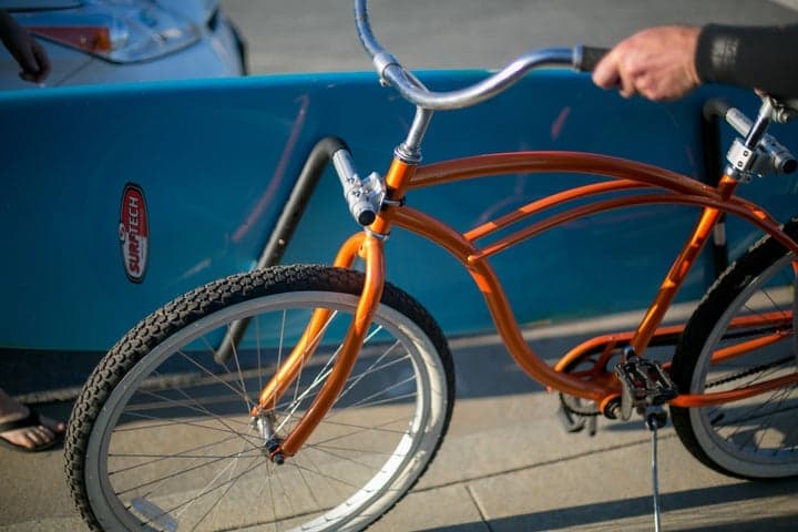 moved by bikes surfboard bike rack - longboard on a bike