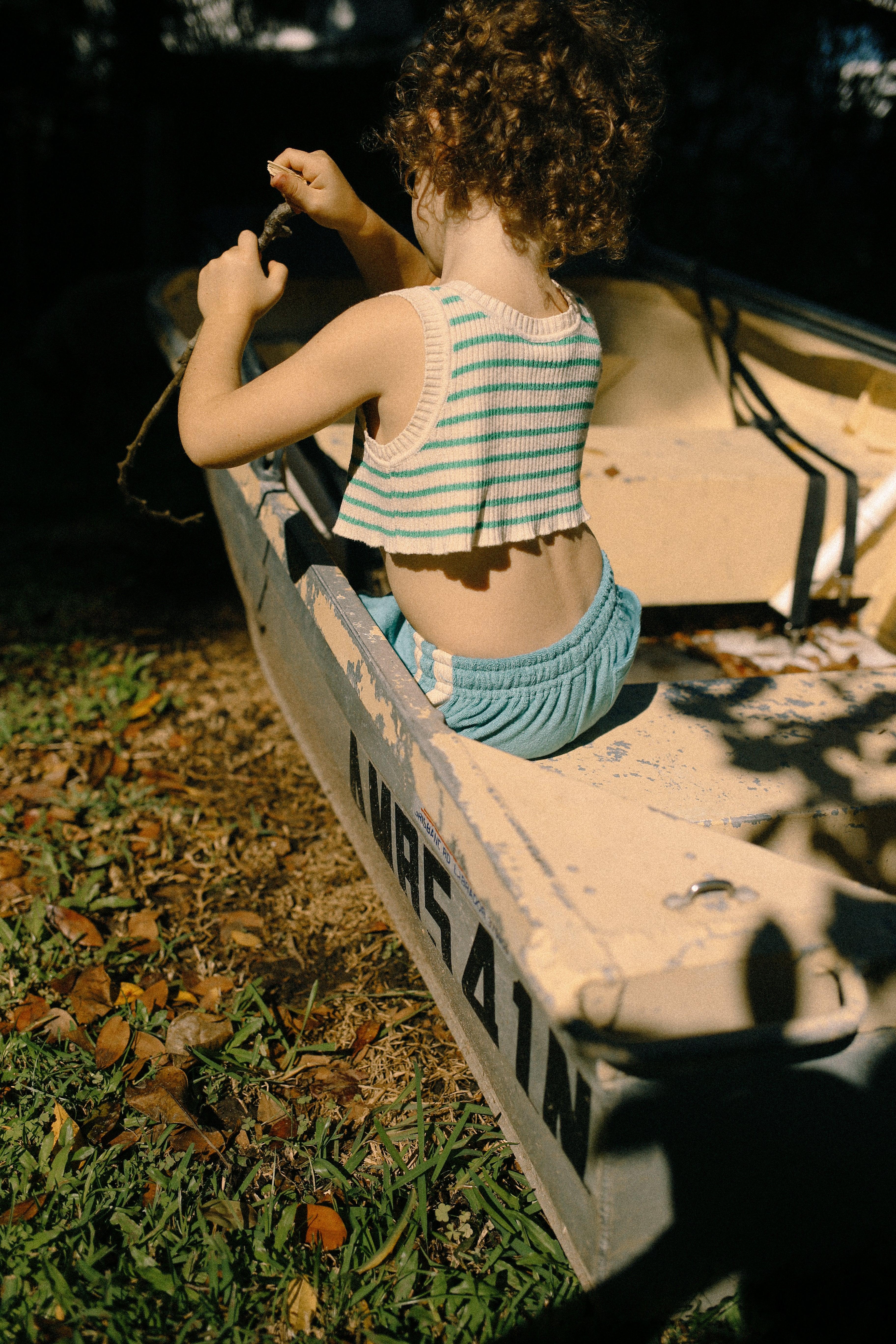 Child in boat with striped top