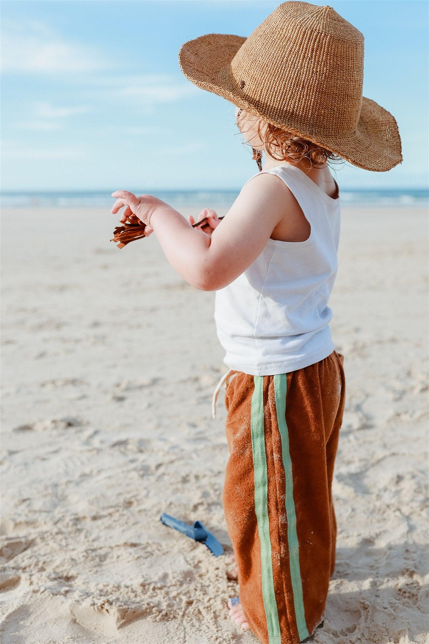 Side view with hat on beach