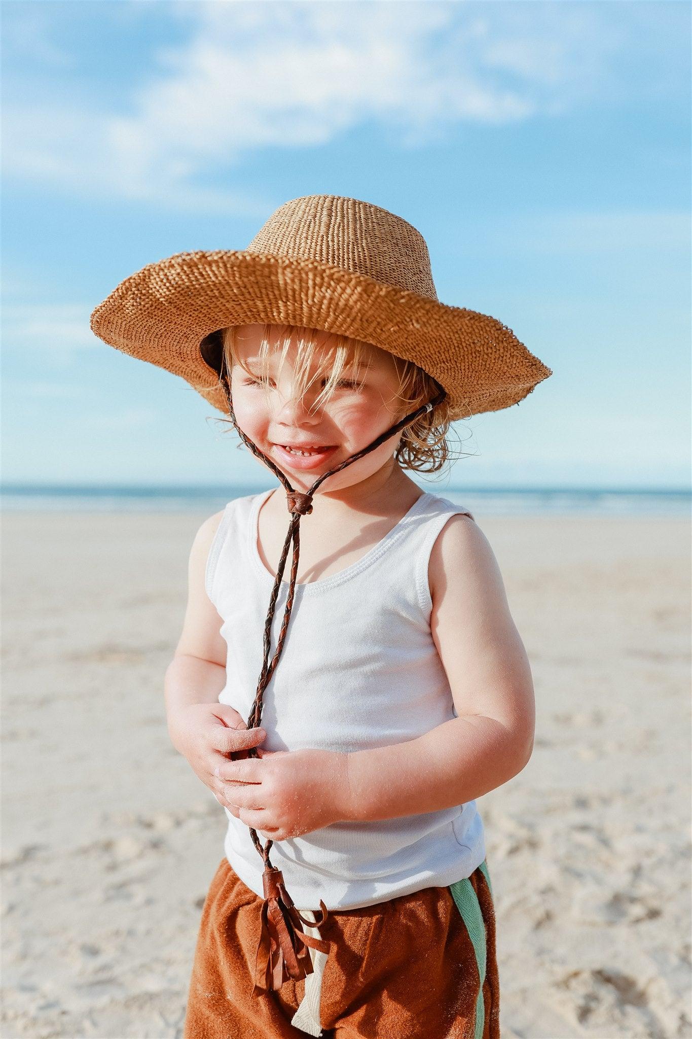 Child with hat smiling
