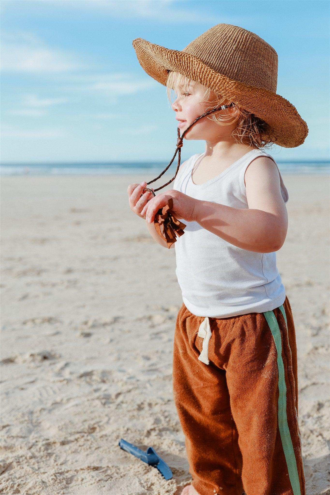Child with hat looking down