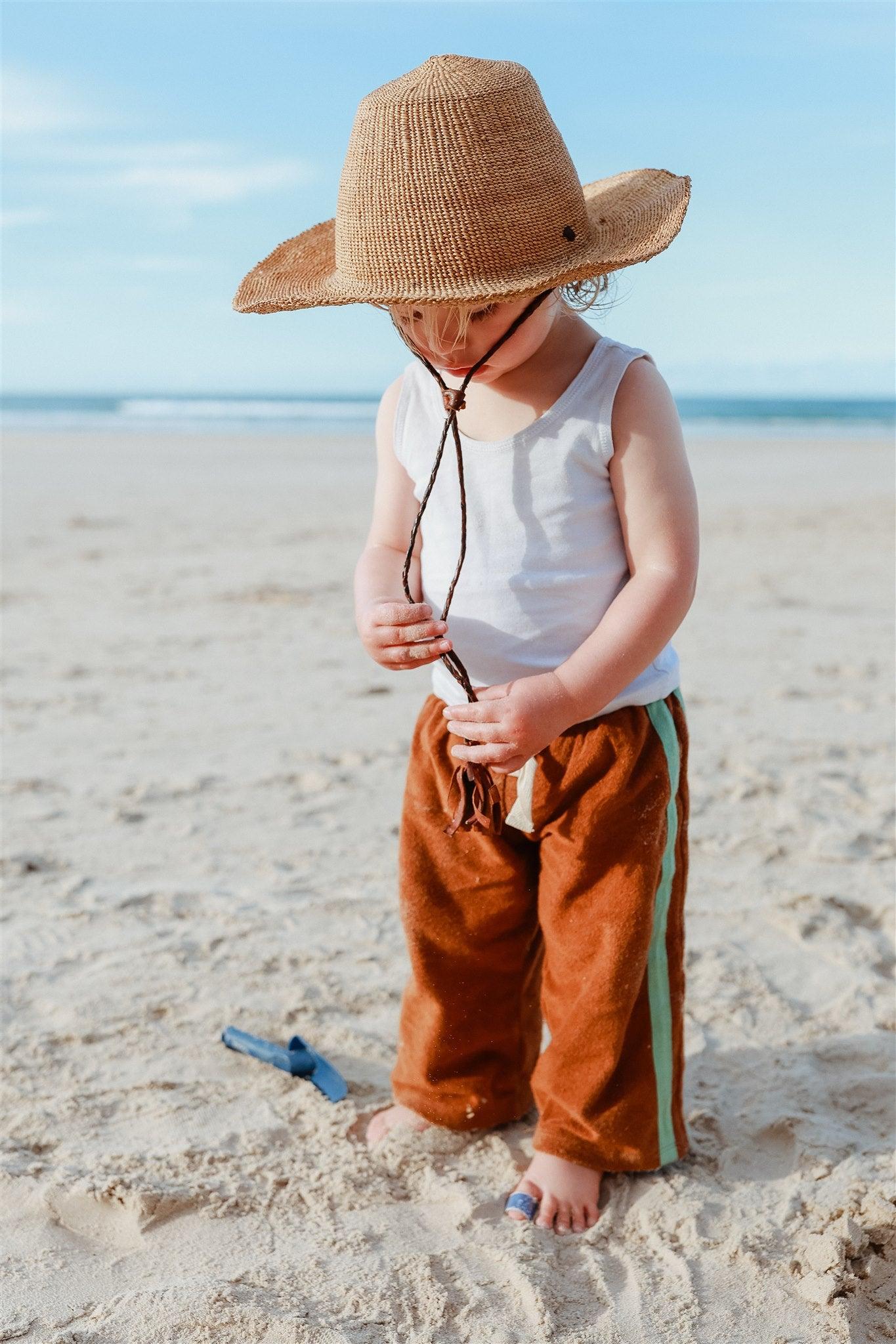 Back view with hat on beach