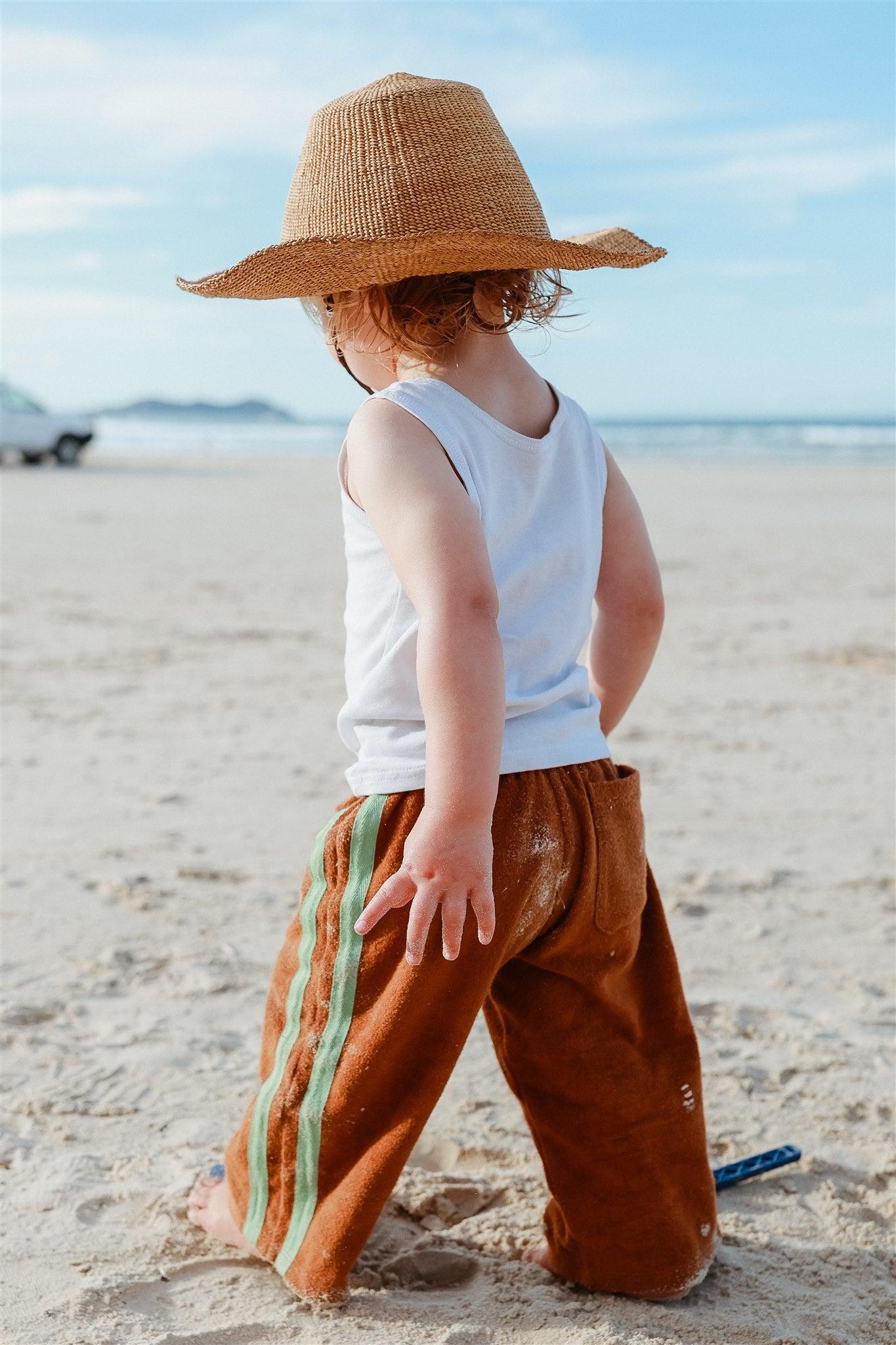 Child with hat looking sideways