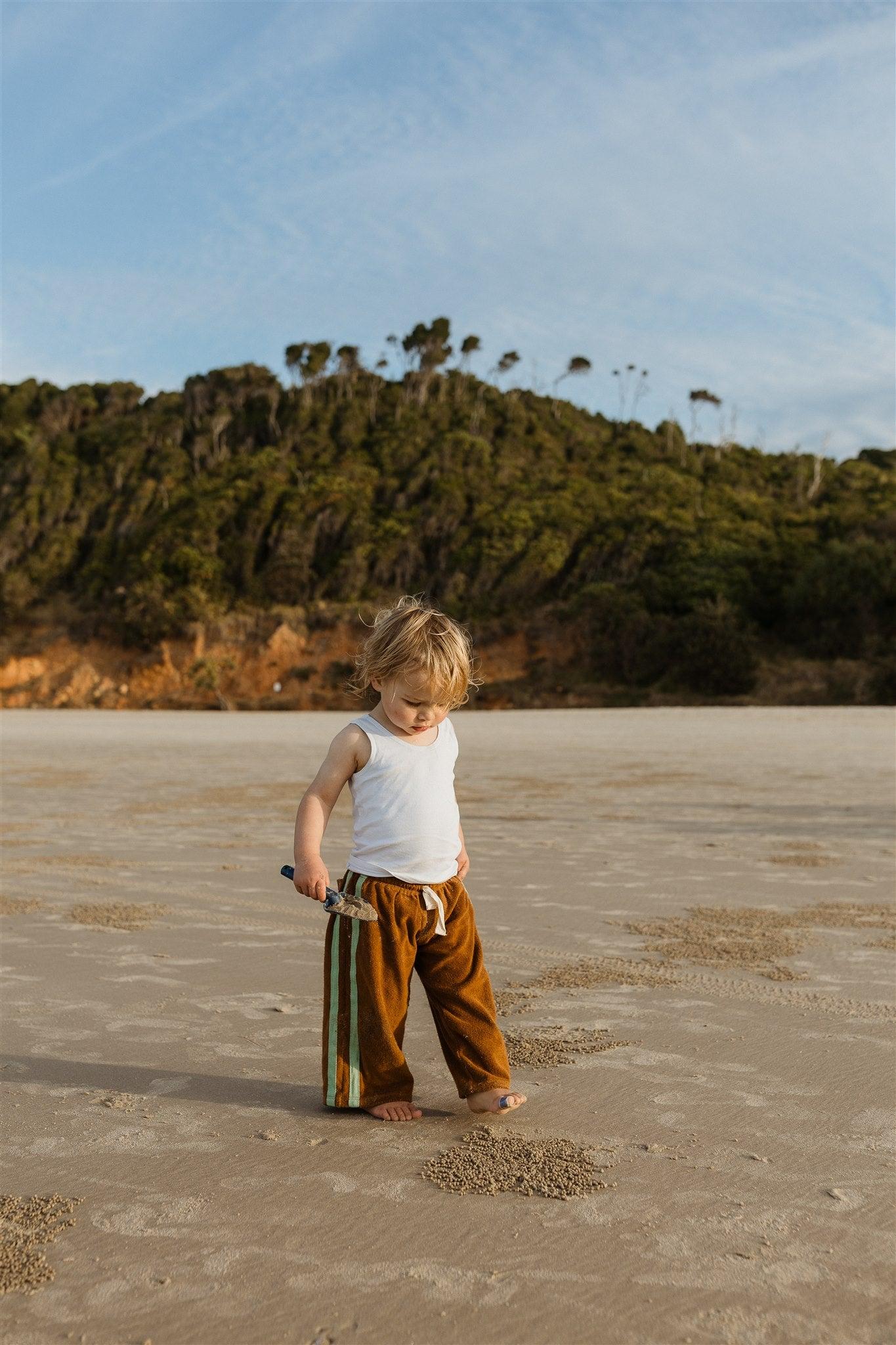 Child with hat on beach
