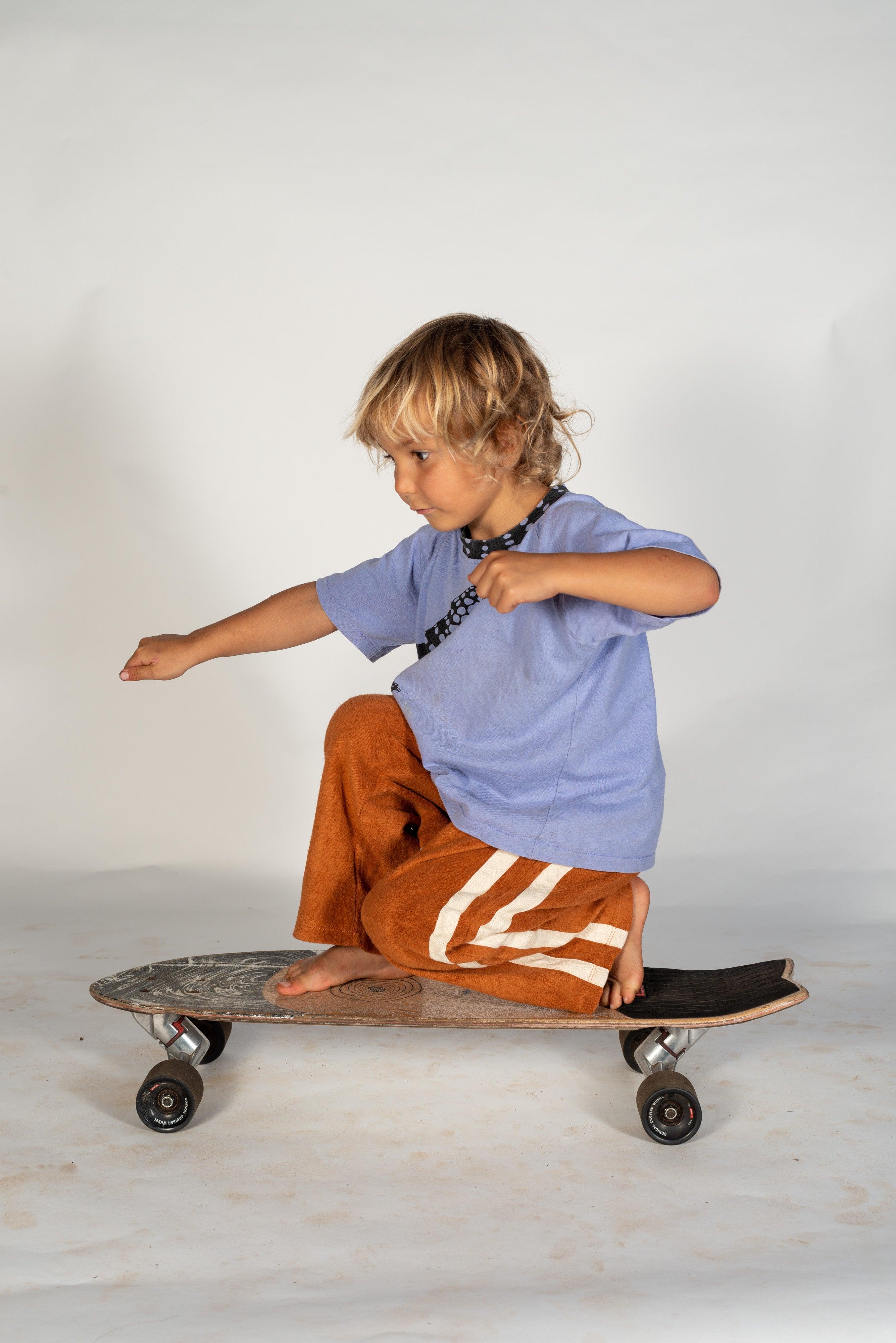 Child on skateboard side view