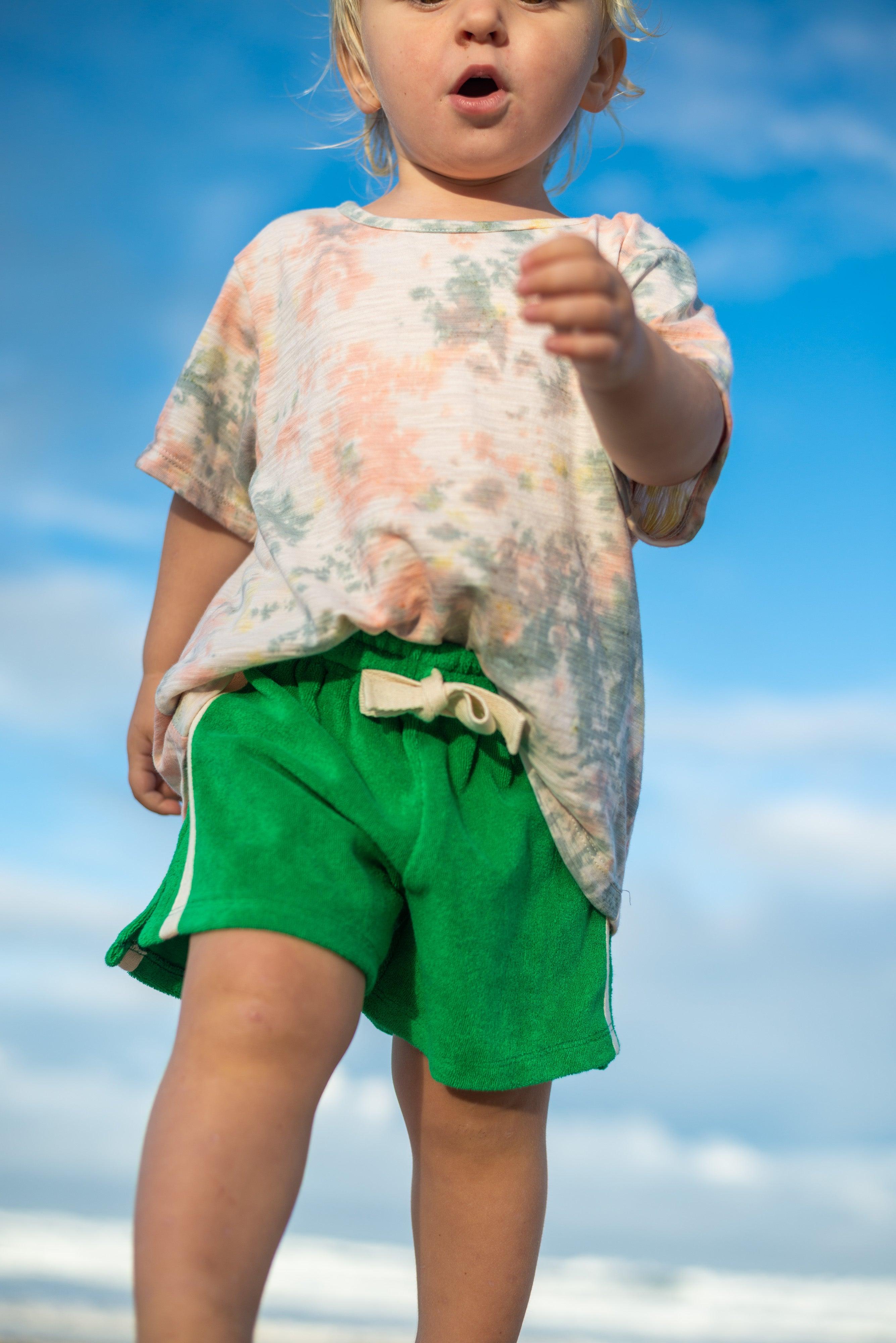 Green shorts on beach