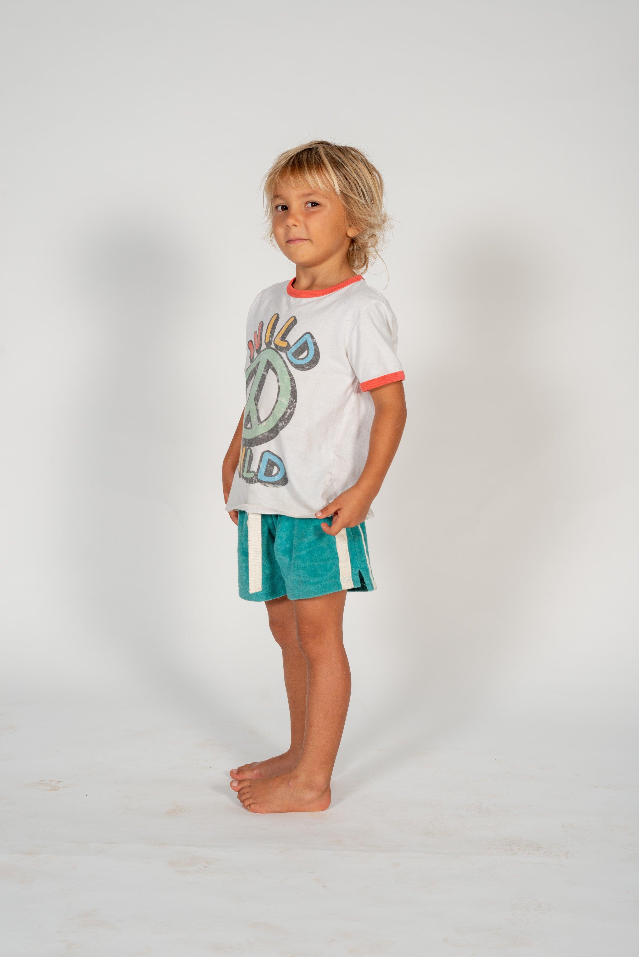 Child on skateboard lying down