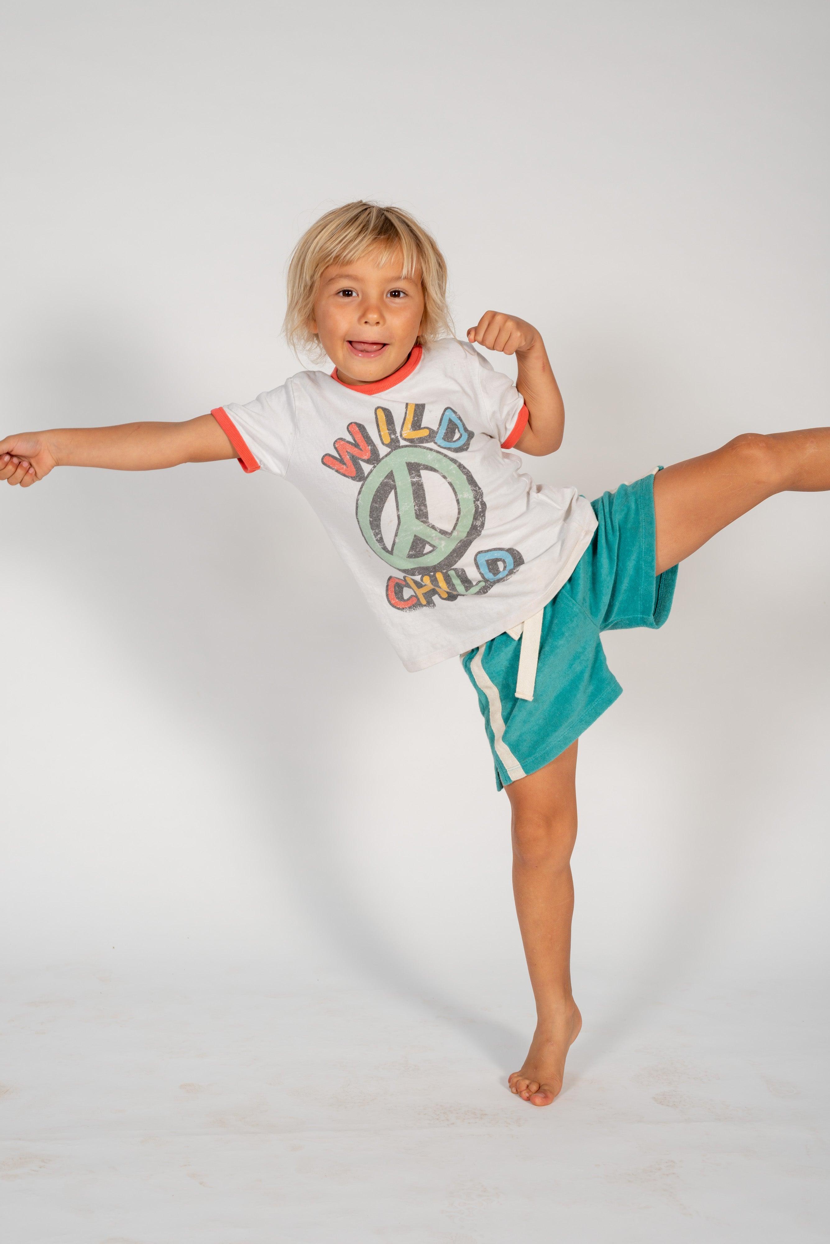 Child in shorts on white background