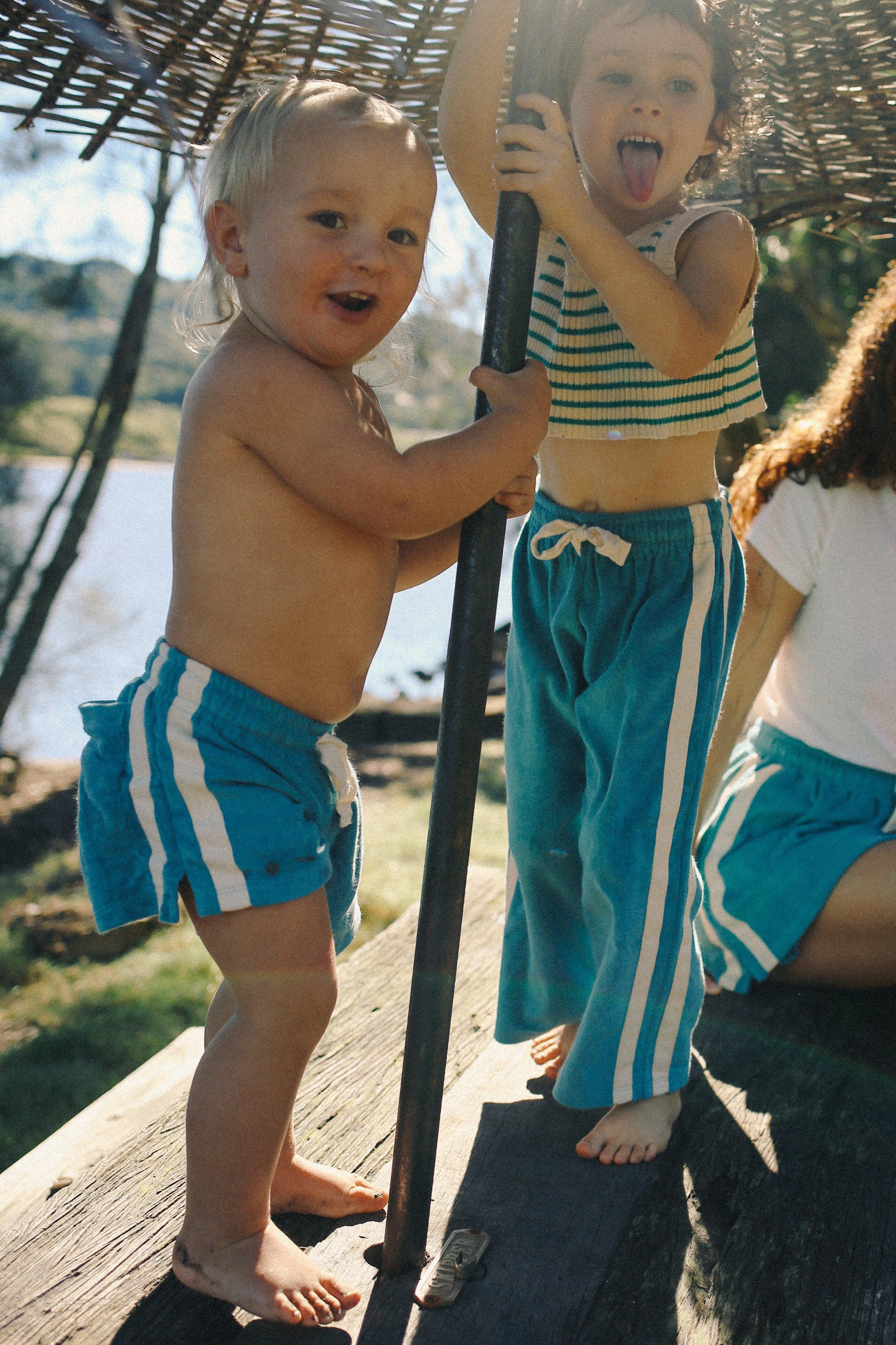 Children playing under umbrella