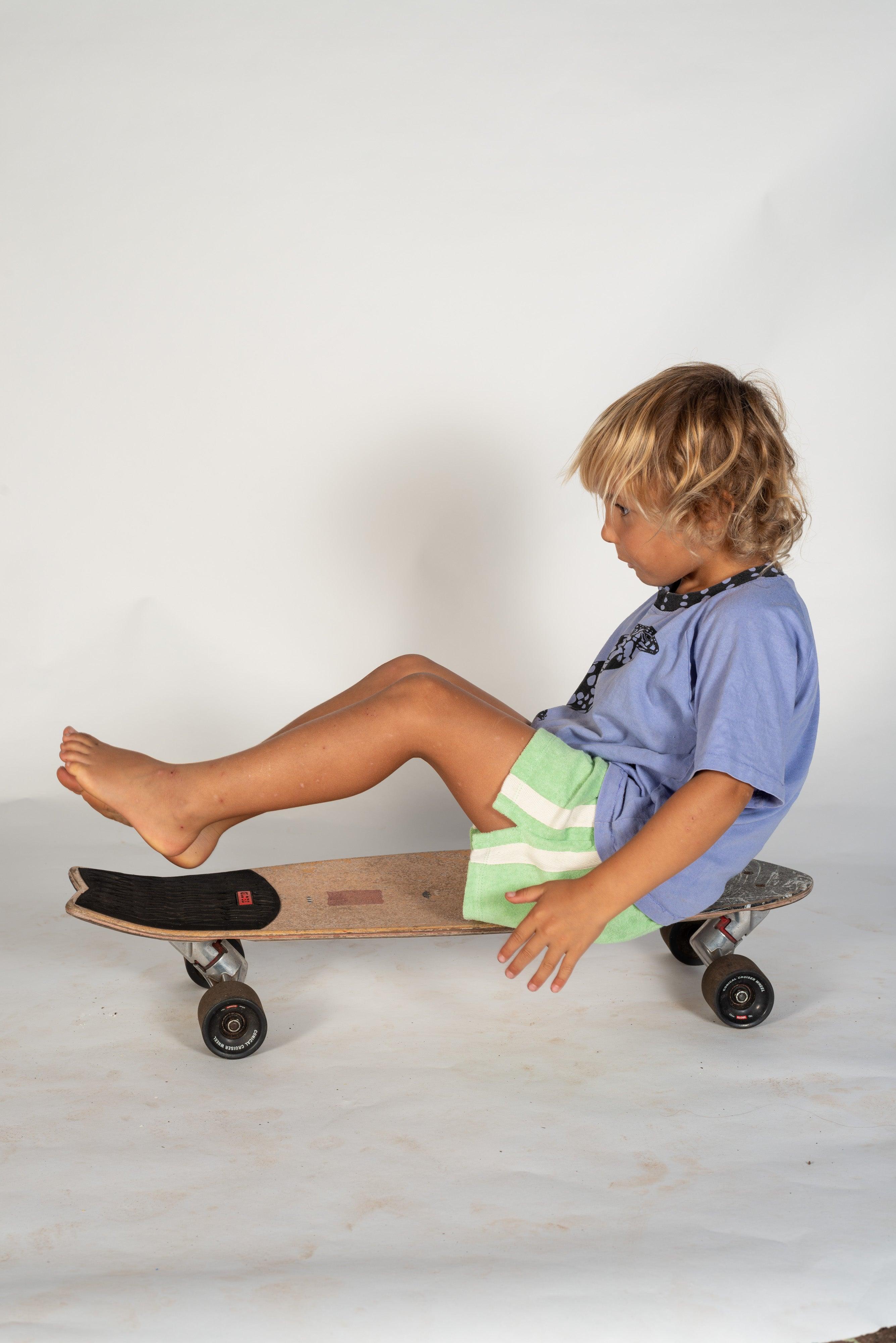 Mint shorts on skateboard sitting