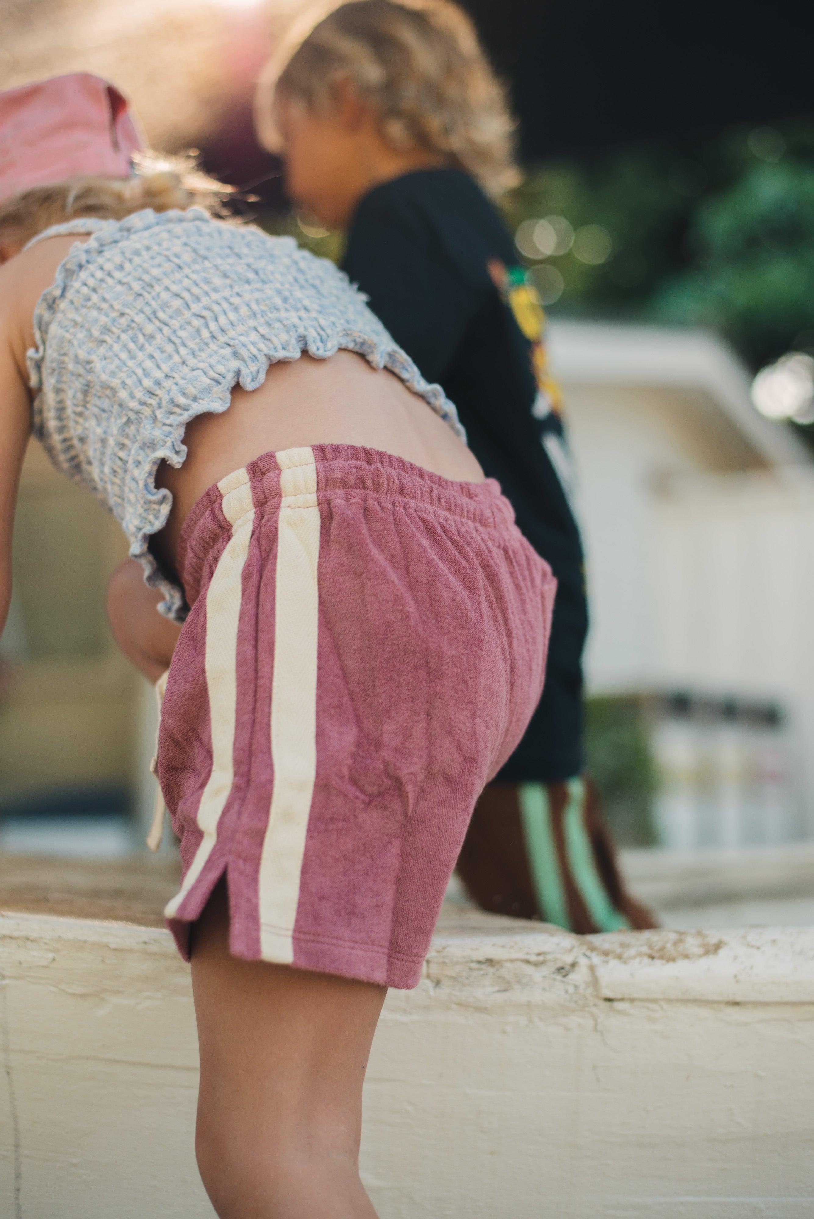 Child sitting with legs up