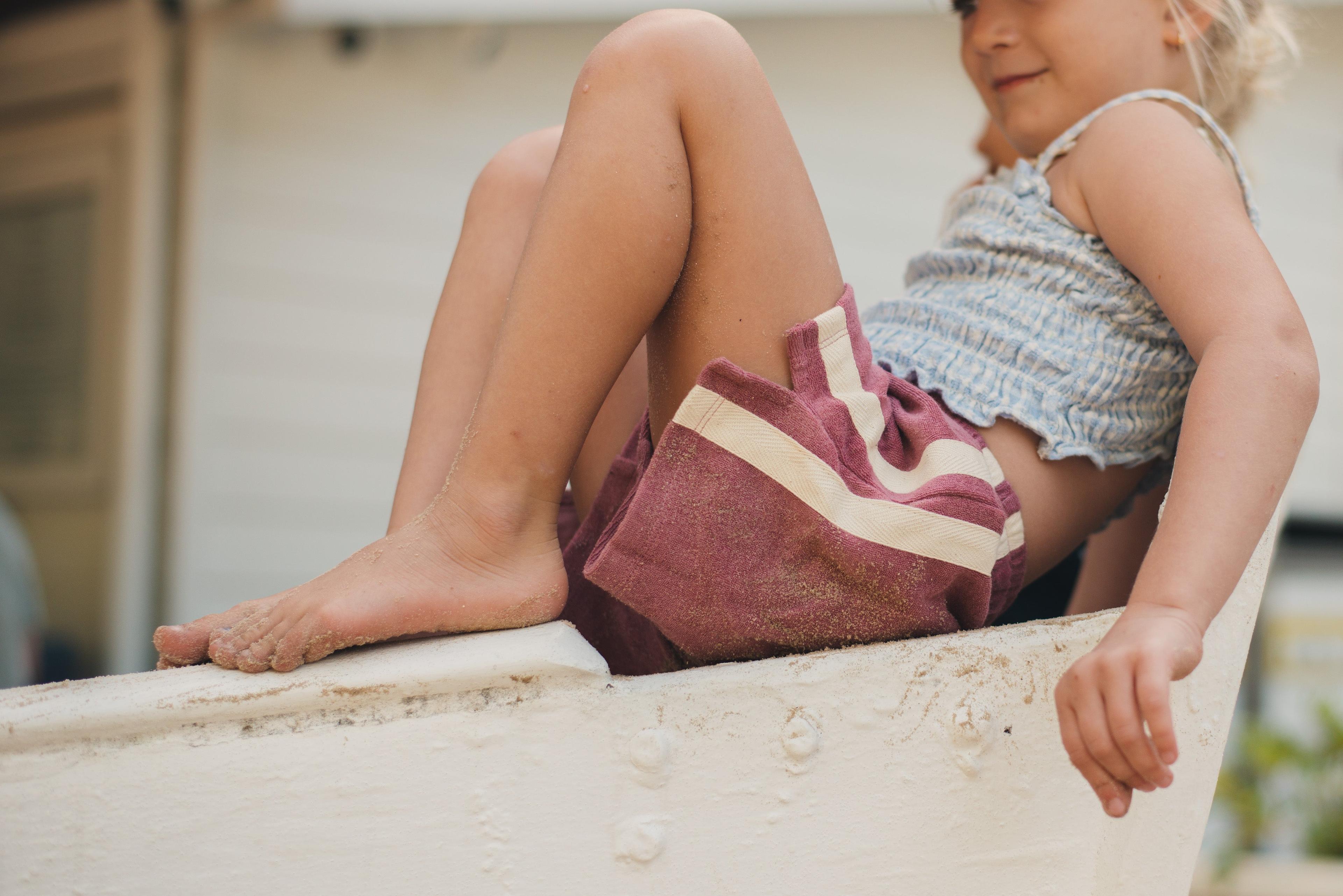 Child sitting on boat edge