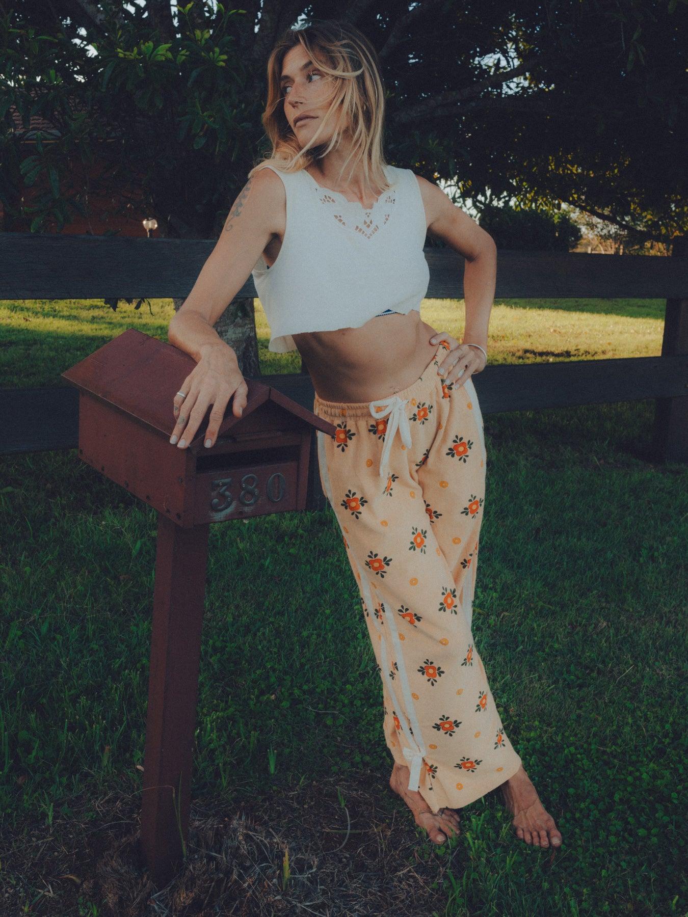 Model wearing pants by mailbox
