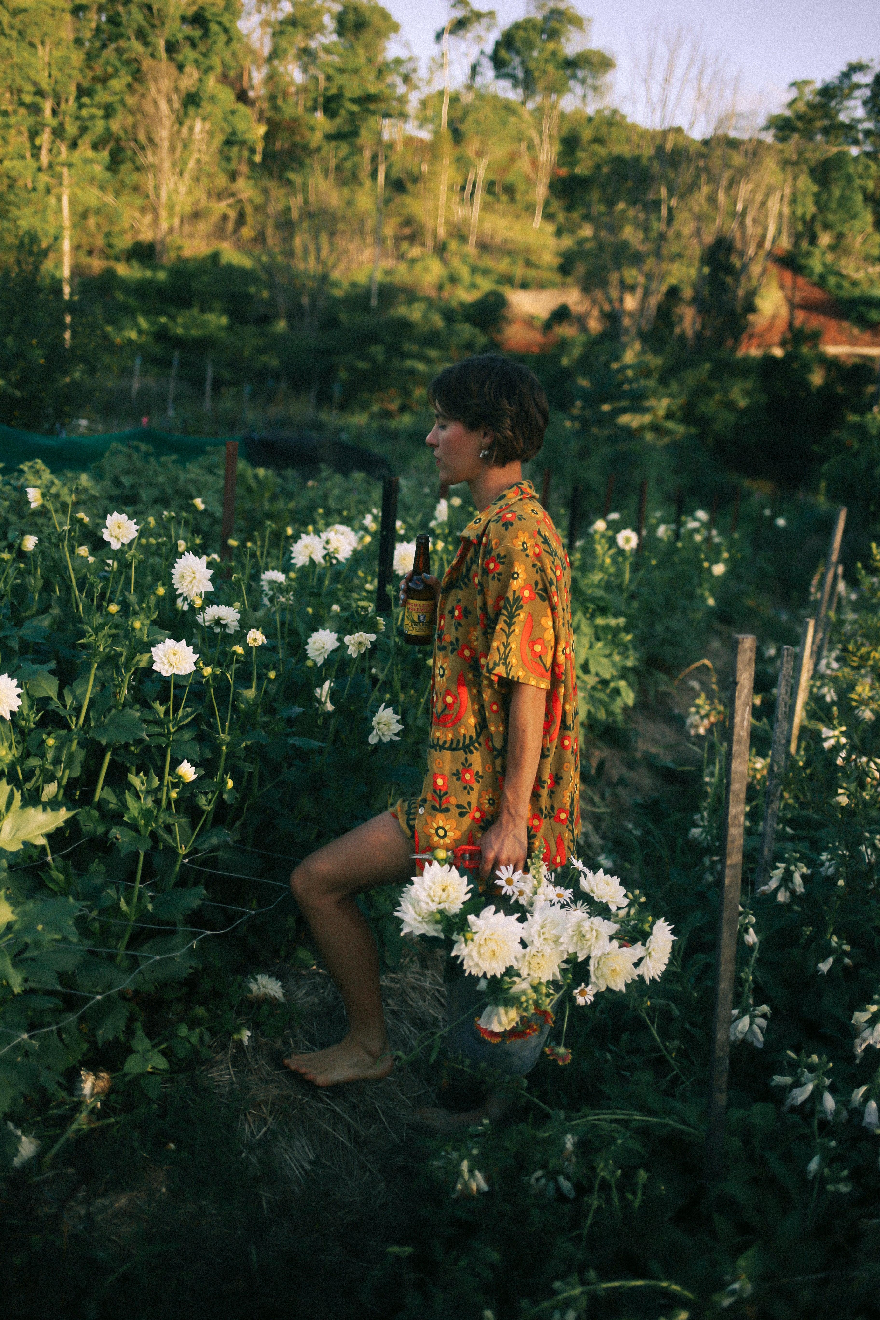 Shirt in garden holding flower