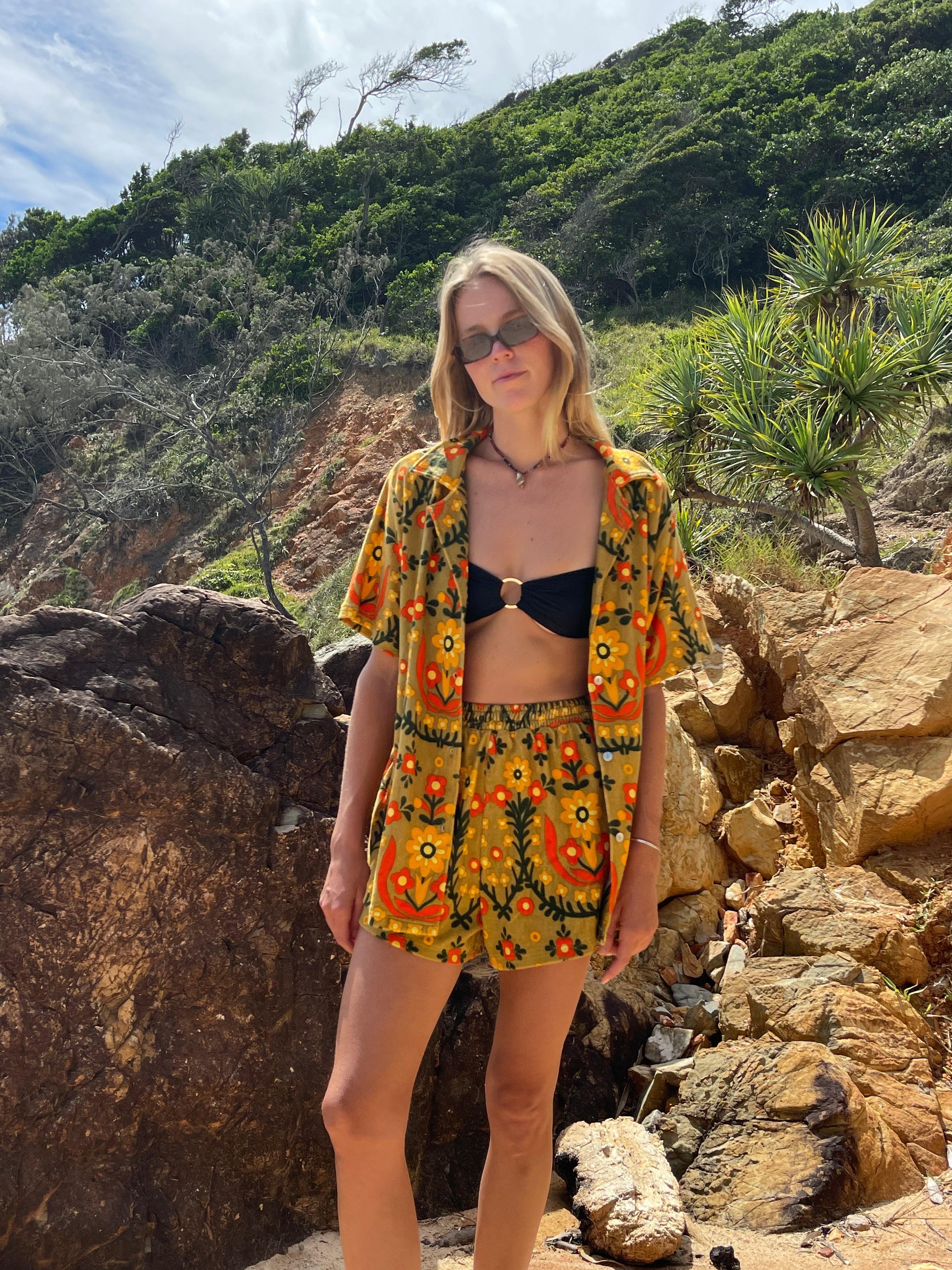 Shirt with black bikini on rocks