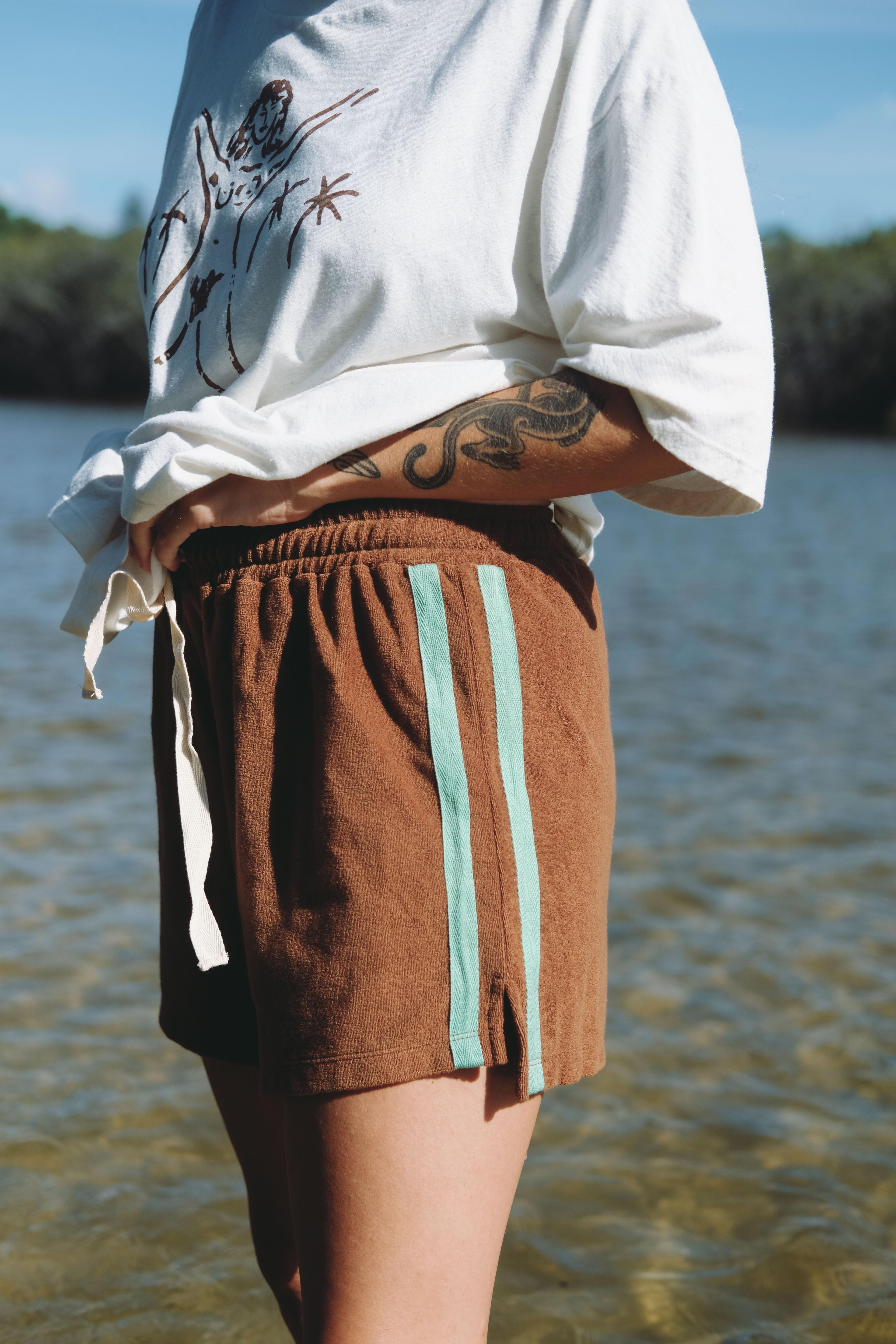 Model wearing shorts with white top