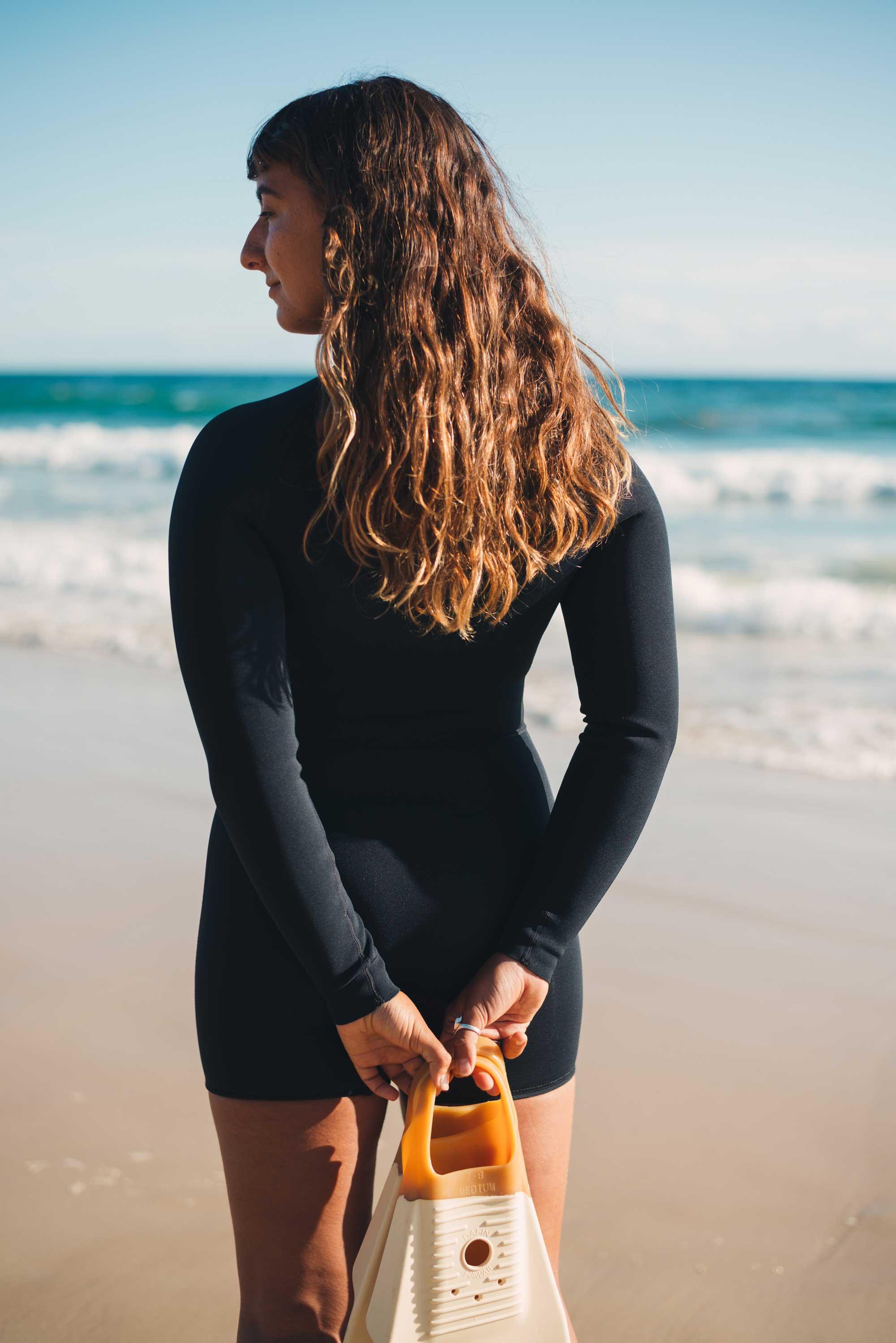 Wetsuit on beach shading eyes
