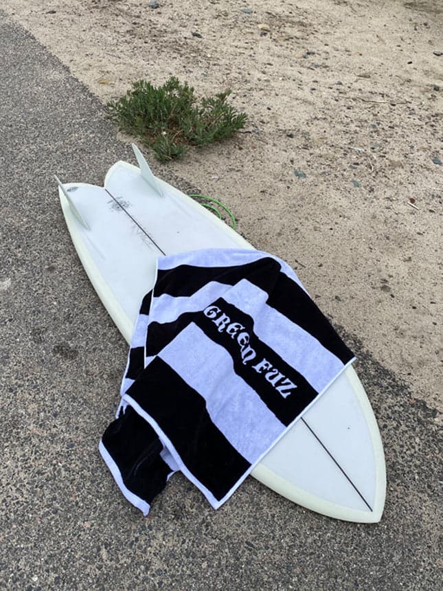 Green Fuz Beach Towel on surfboard