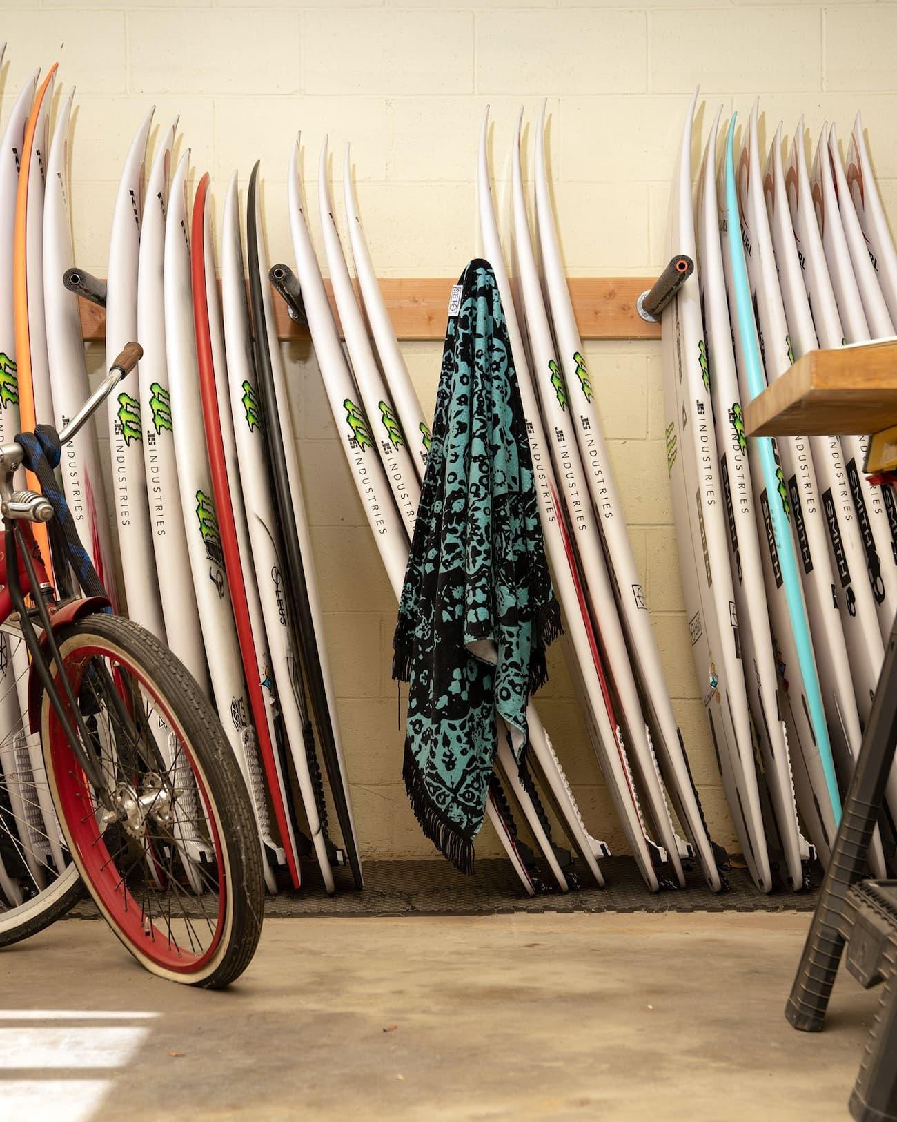 LEUS Conner Coffin Beach Towel hanging on surfboards