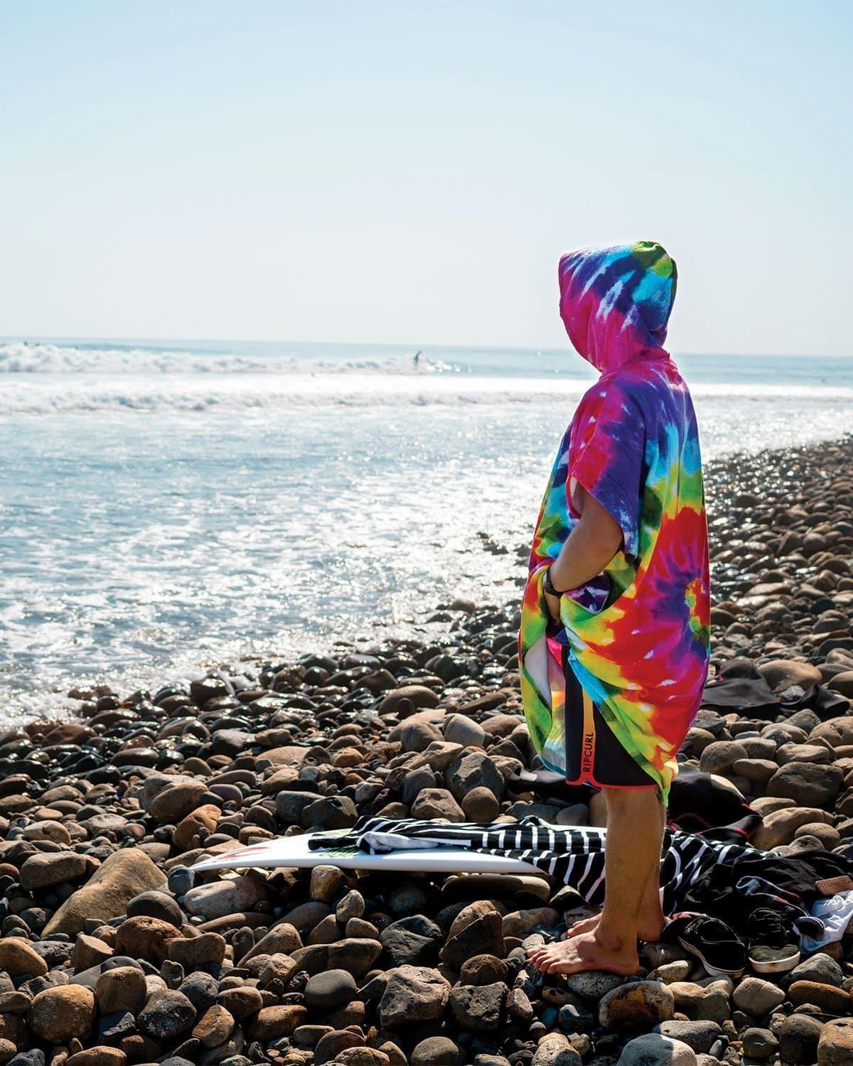 LEUS Tie Dye Changing Poncho Towel on the rocks