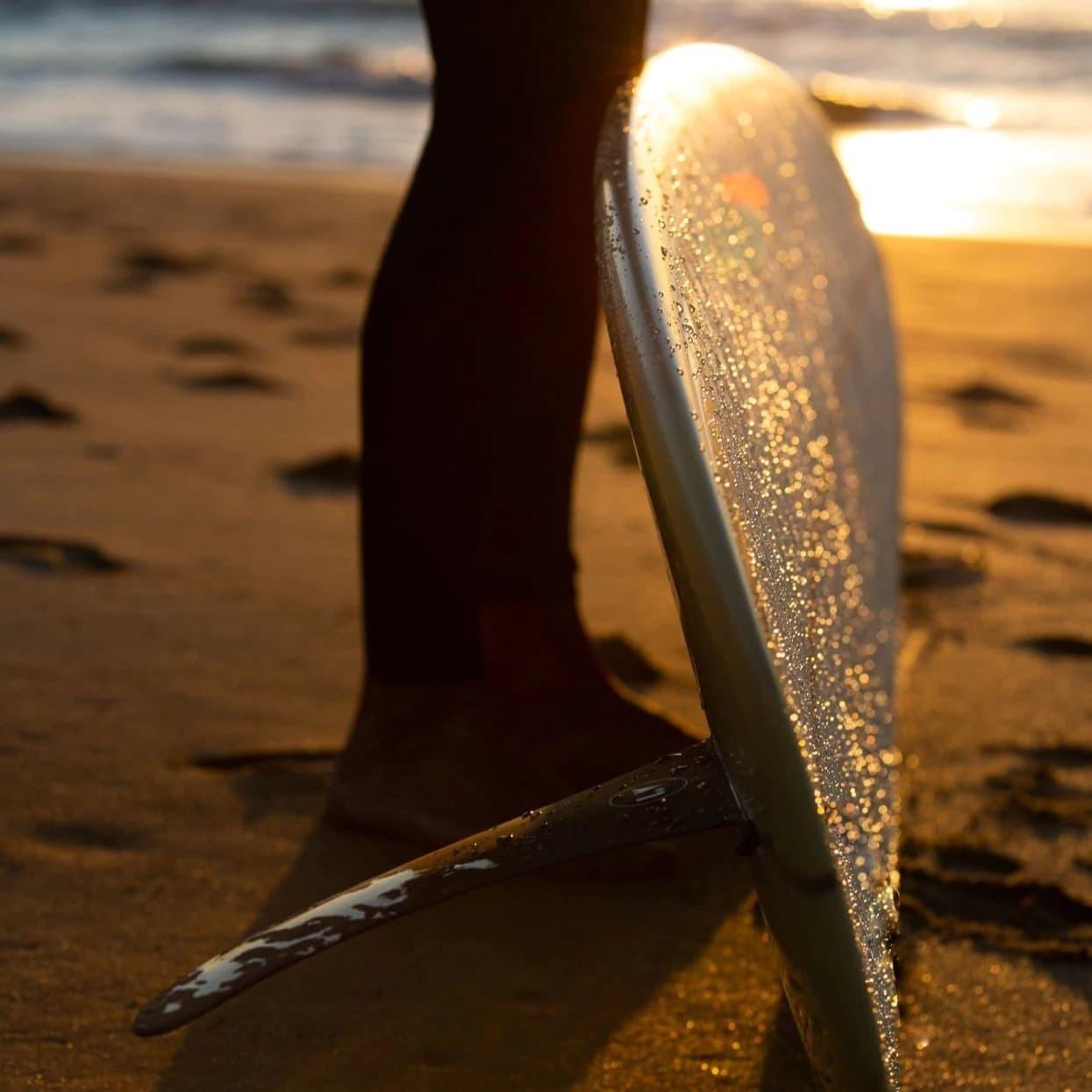 LVfins LB Classic Raked Single Fin - Tannin on longboard surfboard at sunset