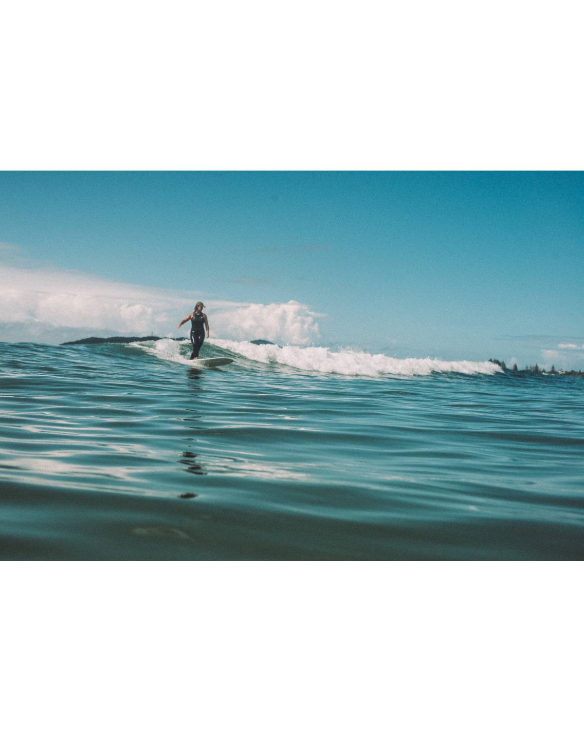 Atmosea Dad Cap - Vintage Khaki on surfer catching a wave