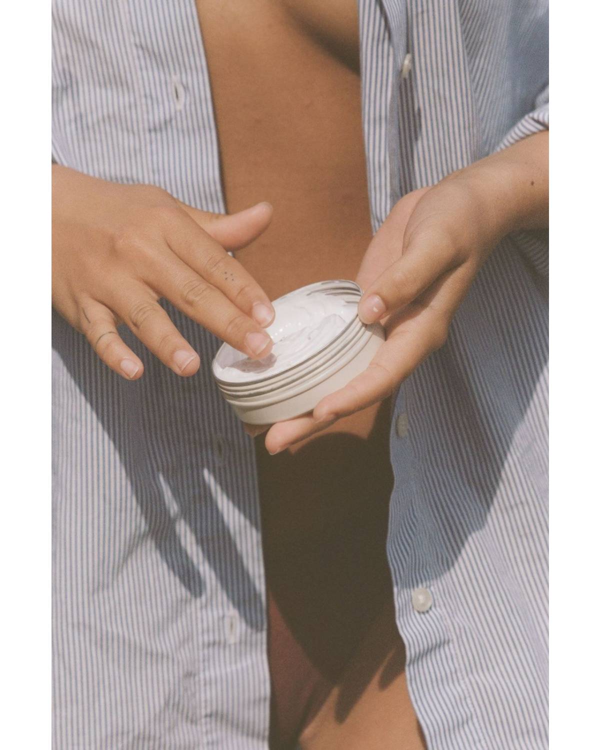 Sun Juju Mineral Based SPF50 Sunscreen Cream on fingers